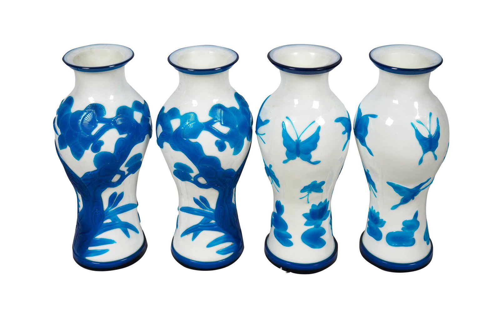 FOUR CHINESE BLUE & WHITE PEKING GLASS VASES: Condition: each good with no apparent damages. Minor shelf wear to undersides. Adhesive residue to undersides. Provenance: Estate of Donald Simon, son of Norton Simon each 14 inches high