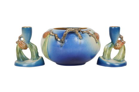 THREE PIECES ROSEVILLE POTTERY PINECONE BLUE: 1930s, comprising a vase and a pair of candlesticks the vase: 6 1/2 inches diameter; 4 inches high; the candlesticks: 4 inches high