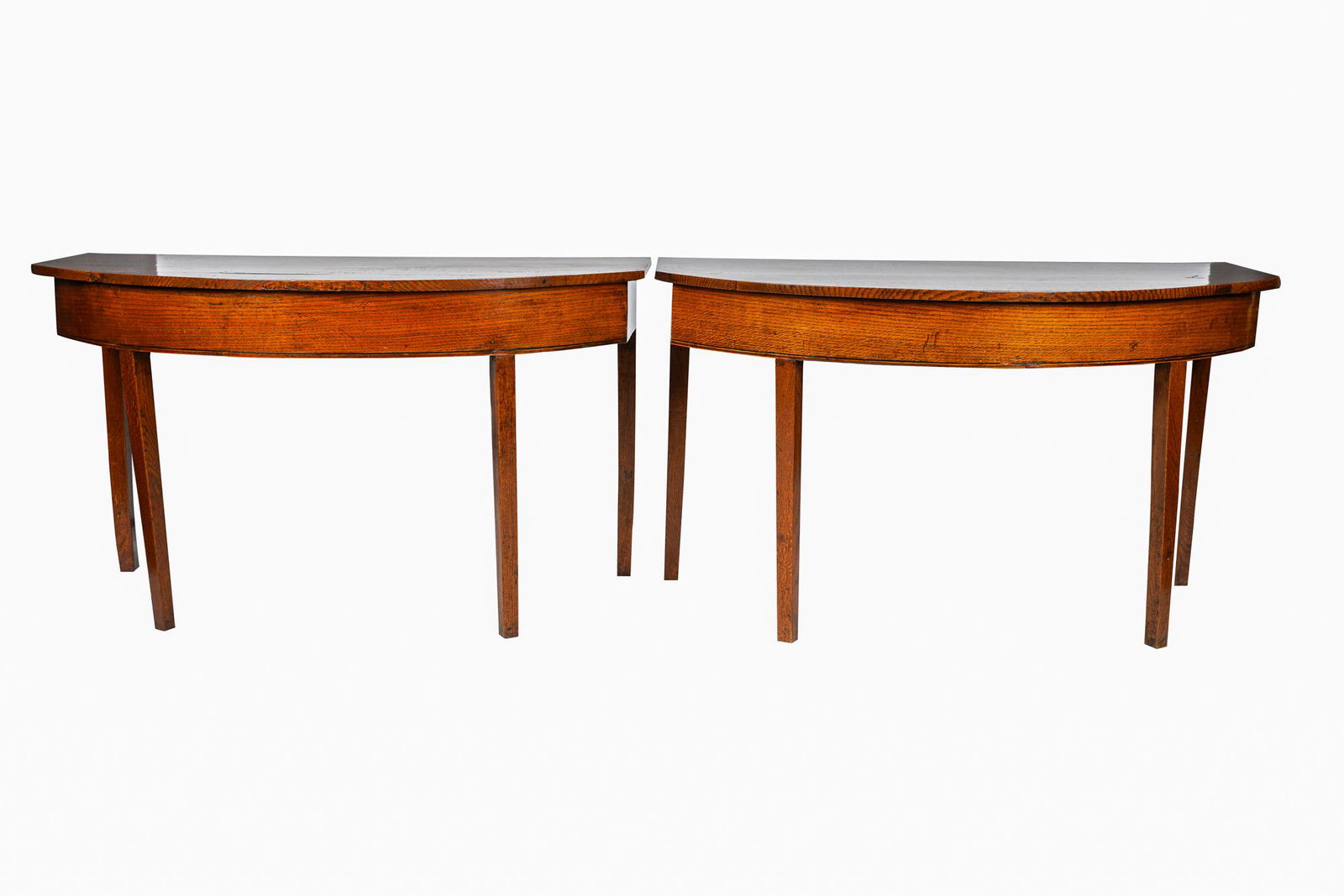 PAIR OF OAK DEMI-LUNE CONSOLE TABLES: 19th century Condition: with attached hardware to join the pair to form one table. General marks, nicks, scratches and shrinkage cracks commensurate with age and use. Splits and gouges to tops. 48 inc