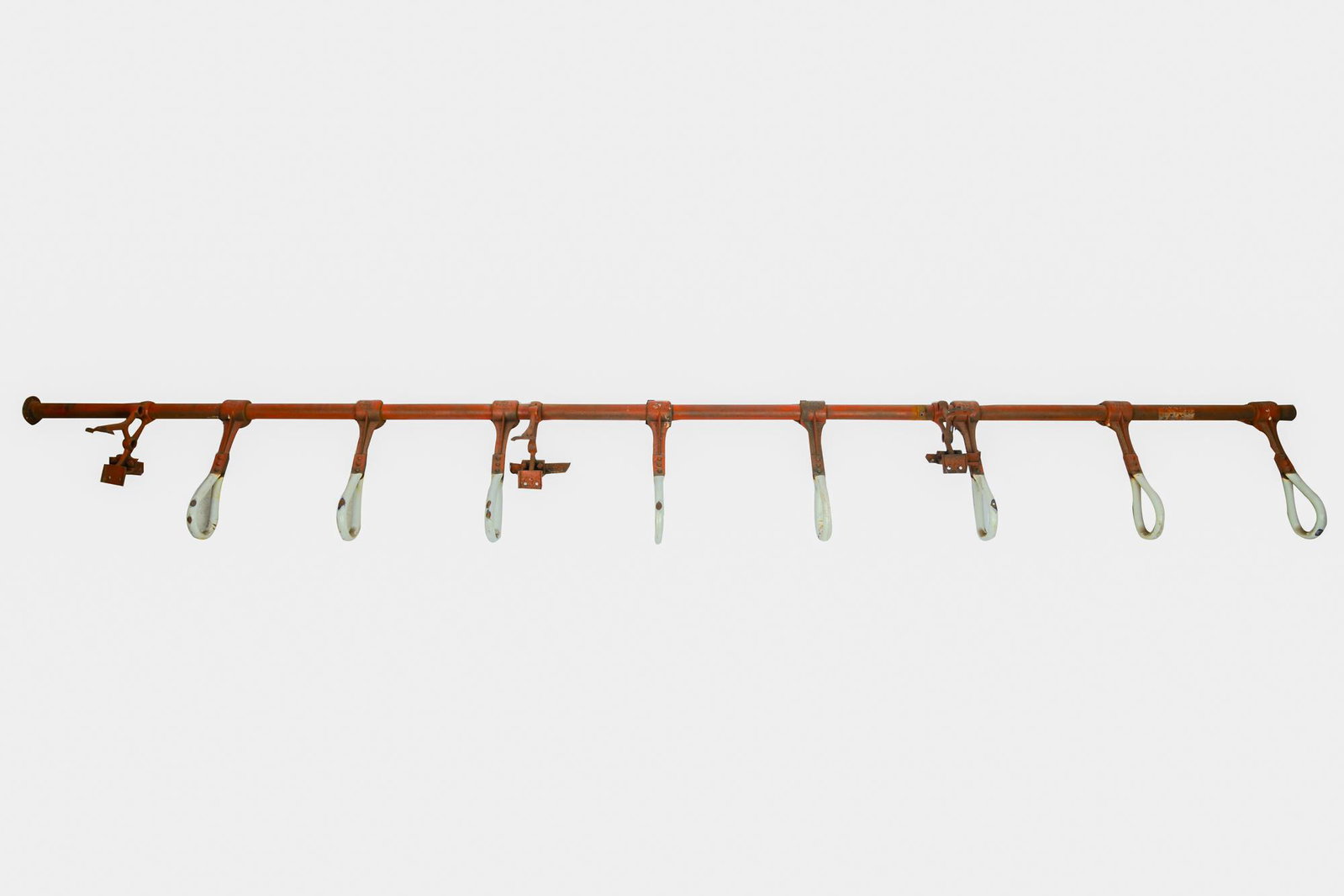 RED & WHITE HANGING RACK: painted iron with enamel coated hanging rings Condition: lightly weathered and with loss to enamel from use 118 inches wide