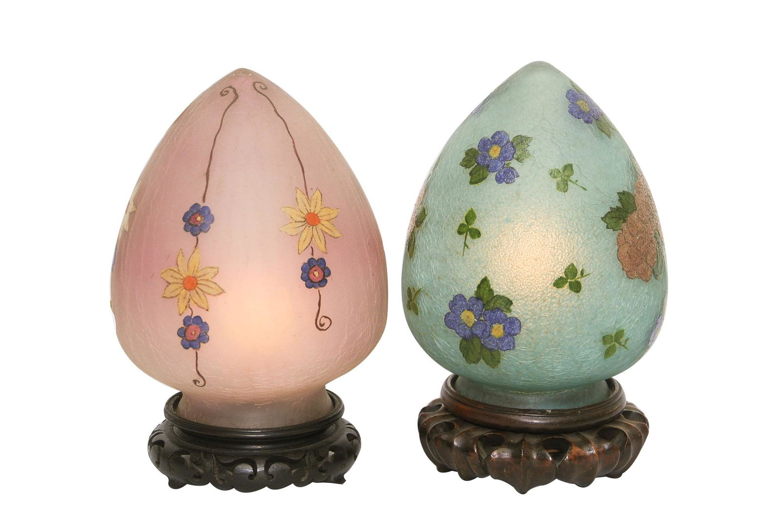TWO HANDEL FLORAL EGG FORM SHELF LAMPS PAINTED BY: each lamp circa 1924 each lamp with "chipped ice" glass exterior painted floral shades each lamp on similar round wood stylized bases pink shade signed 7261 F.L. Handel green shade signed Handel 7093