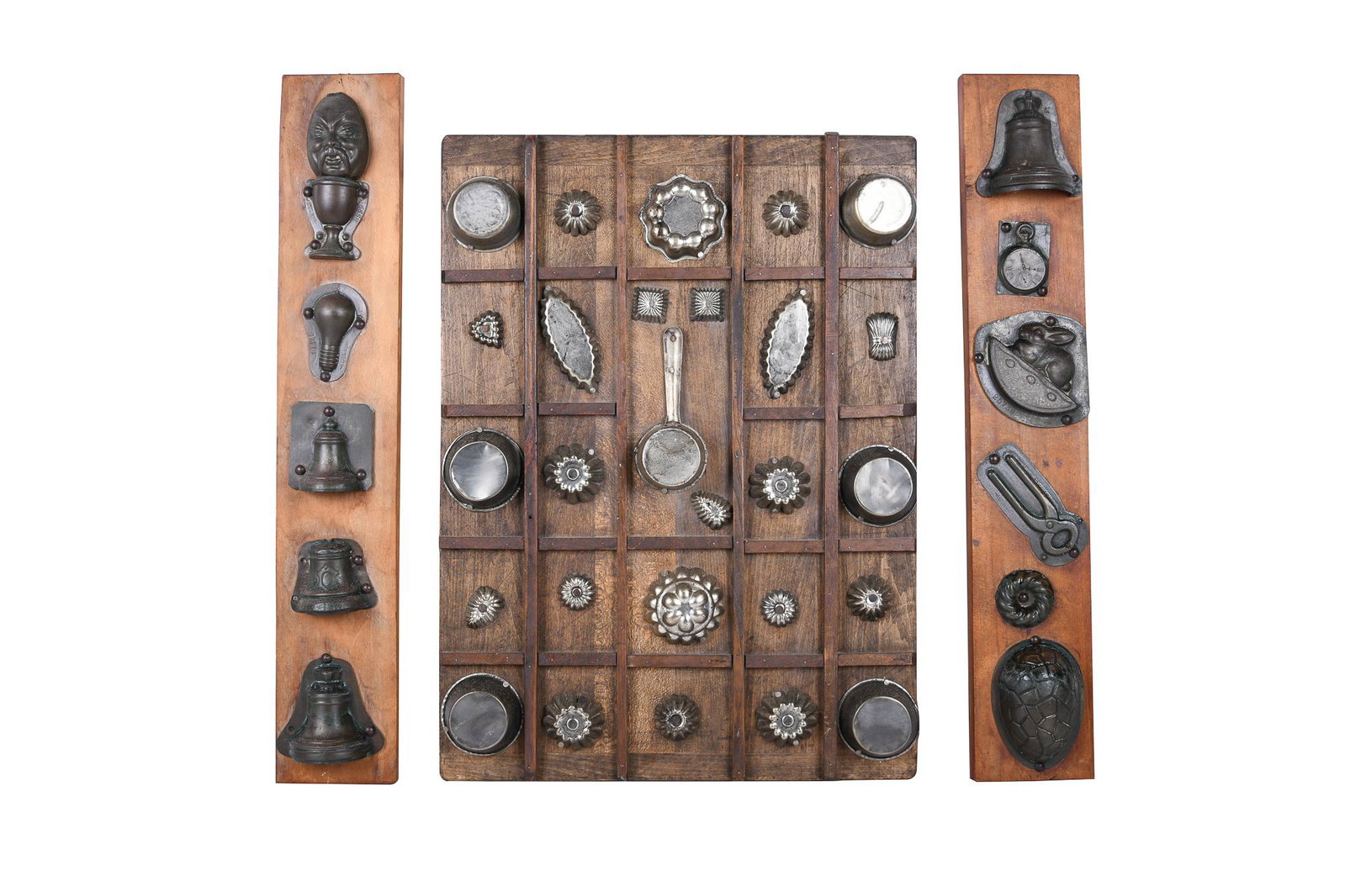 THREE BAKING & CANDY MOLD WALL PLAQUES: circa 20th Century tole, aluminum and various metals 39 total baking and candy molds, depicting caricatures, bells, animals and geometric designs Condition: one mold loose on board large plaque 24 x 1
