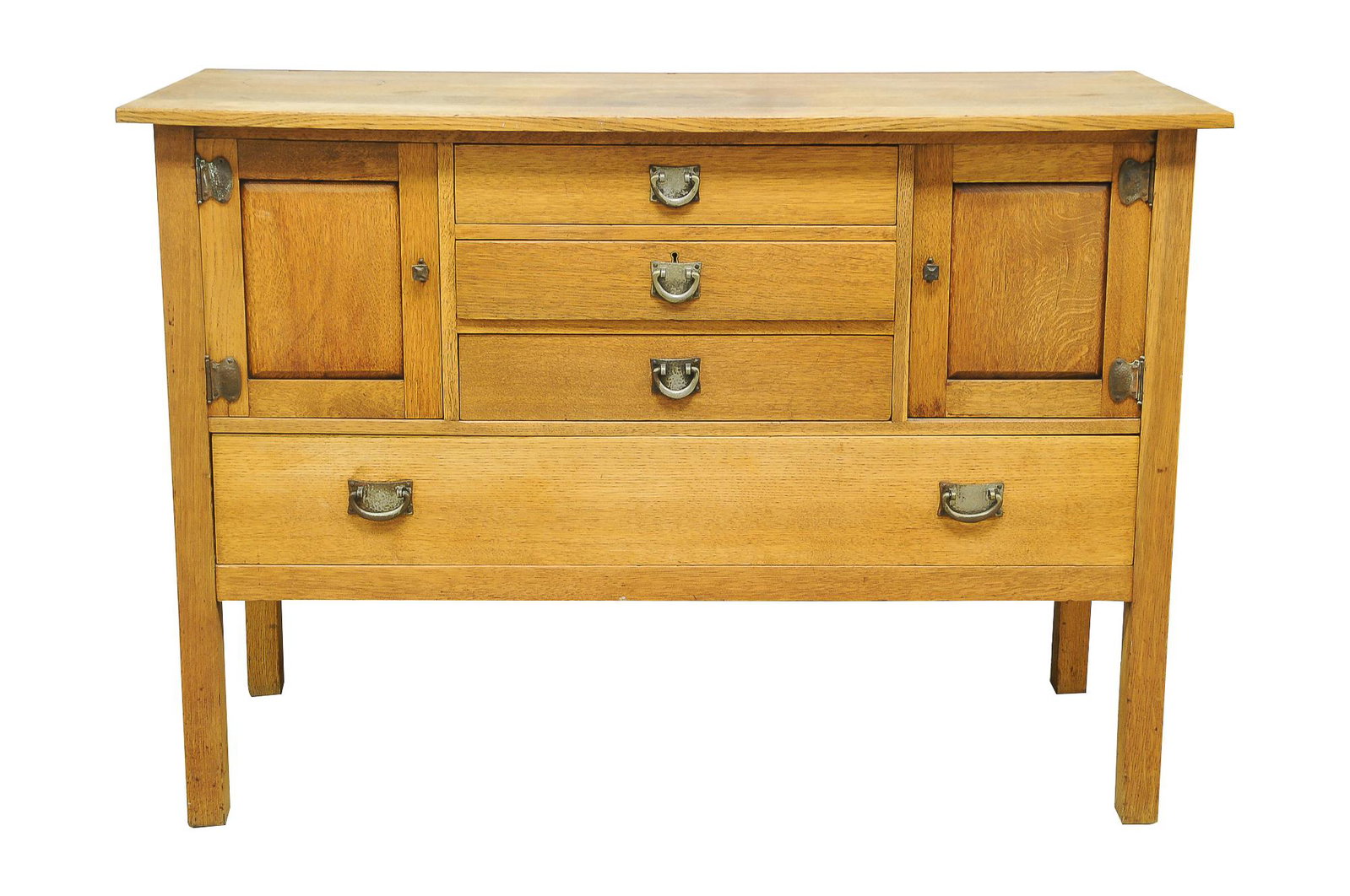 STICKLEY BROTHERS SIDEBOARD: circa 1900-1925; model #8338 oak with hammered metal hardware with three drawers flanked by two cupboard doors over a long drawer Condition: finish faded throughout; several ring marks and stains to t
