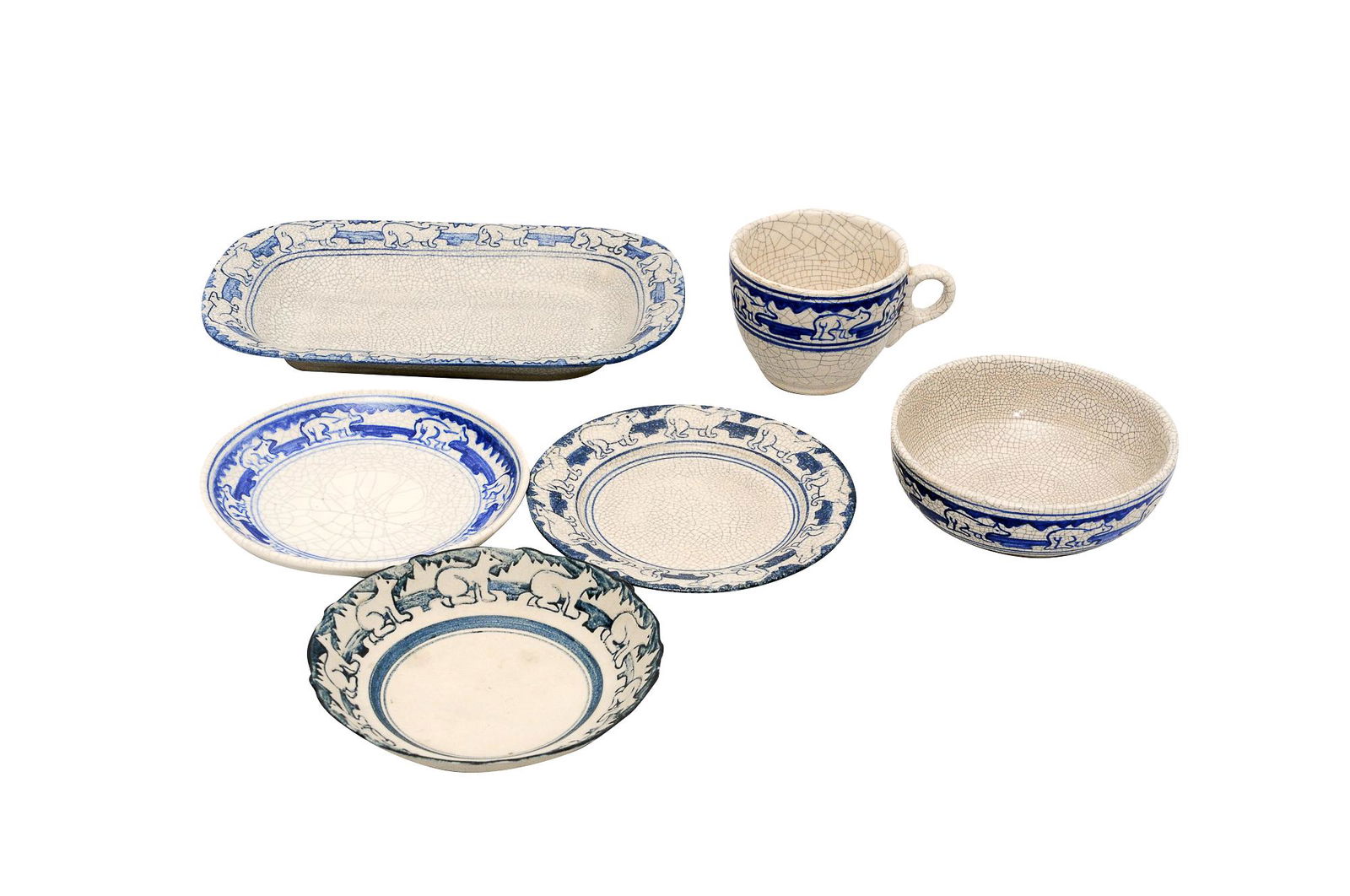 SIX DEDHAM POTTERY POLAR BEAR DISHES: circa first quarter 20th Century the glazed pieces each with square stamped blue mark, the unglazed piece with impressed foreshortened rabbit mark, comprising: a glazed rectangular tray (9 3/4" wide x