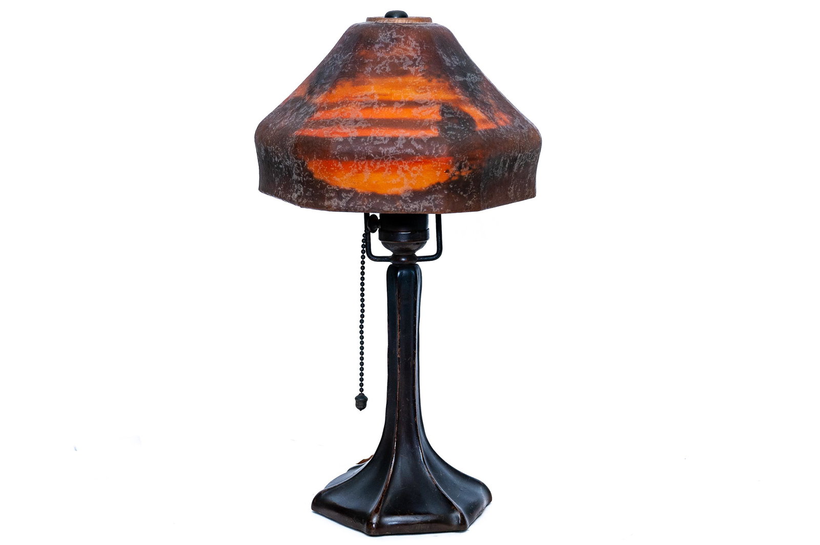 HANDEL SUNSET LANDSCAPE DESK LAMP: circa 1923 reverse painted "chipped ice" glass shade with a patinated bronze base shade depicting a sunset landscape shade signed HANDEL 7067 base signed HANDEL lower Condition: the shade with a chip 