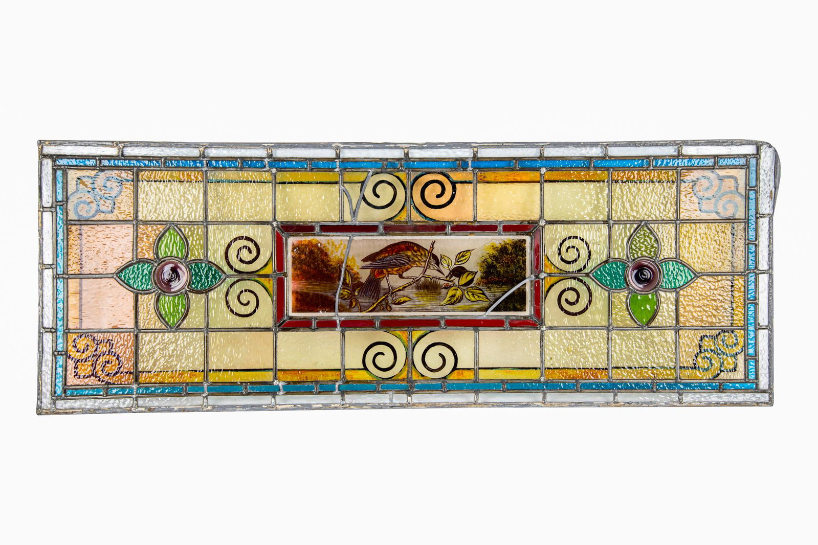 LEADED GLASS PANEL: depicting a central bird flanked by purple glass flowers Condition: with loss to lead binding and crack to glass on upper right corner; repaired throughout 18 1/2 x 50 inches
