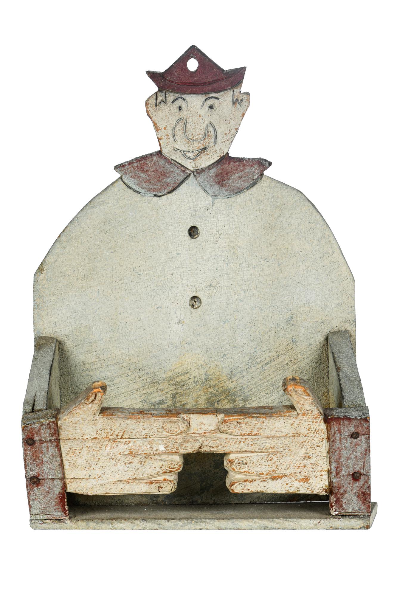 CLOWN WALL SHELF: circa 20th Century painted wood hand carved wall shelf depicting a clown Condition: with paint and wood loss throughout 12 inches wide; 5 inches deep; 17 1/2 inches high