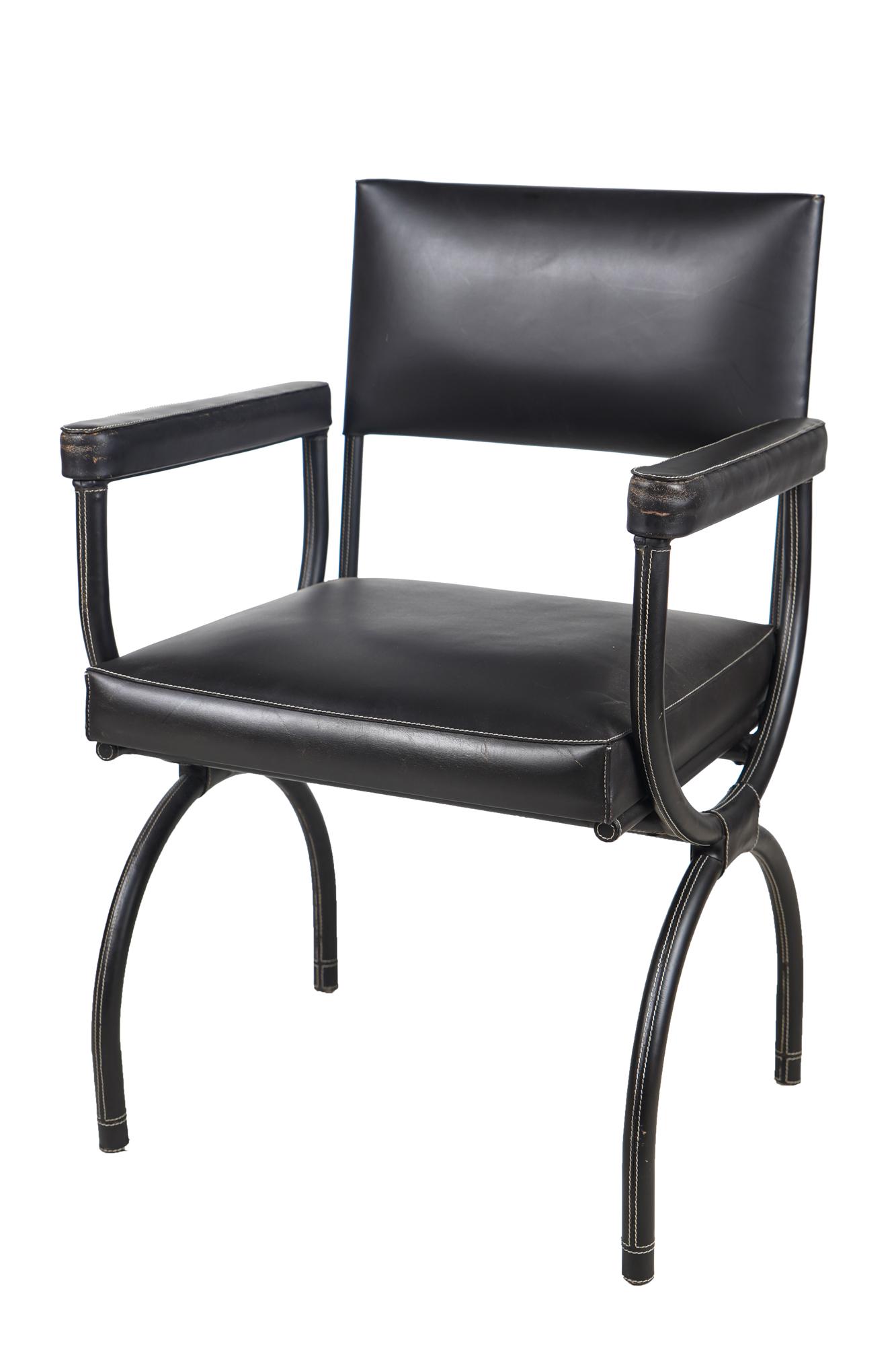 ERIC BRAND JUNIPER LEATHER ARMCHAIR: contemporary, with label to underside, brown leather with white stitching Condition: good with minor wear to arms and a few scattered marks to back and seat. A few scuffs to feet. 24 inches wide; 22 i