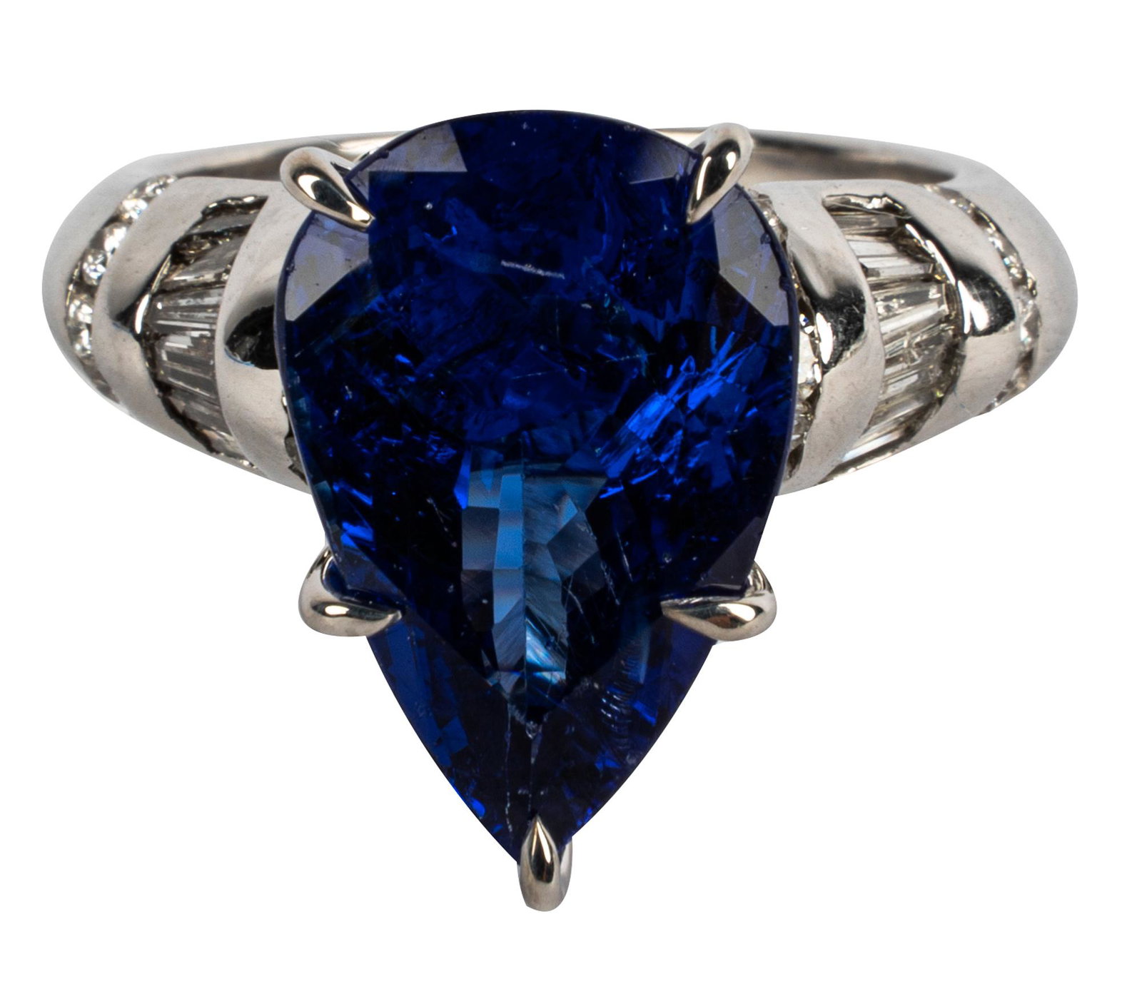 18 KARAT WHITE GOLD, DIAMOND, & TANZANITE RING: centering one pear tanzanite weighing approximately 4.28 carats; 22 full cut diamonds [H/VS] weighing 0.30 carats total; and 12 tapered baguette cut diamonds [H/VS] weighing 0.40 carats total 8.3 gram