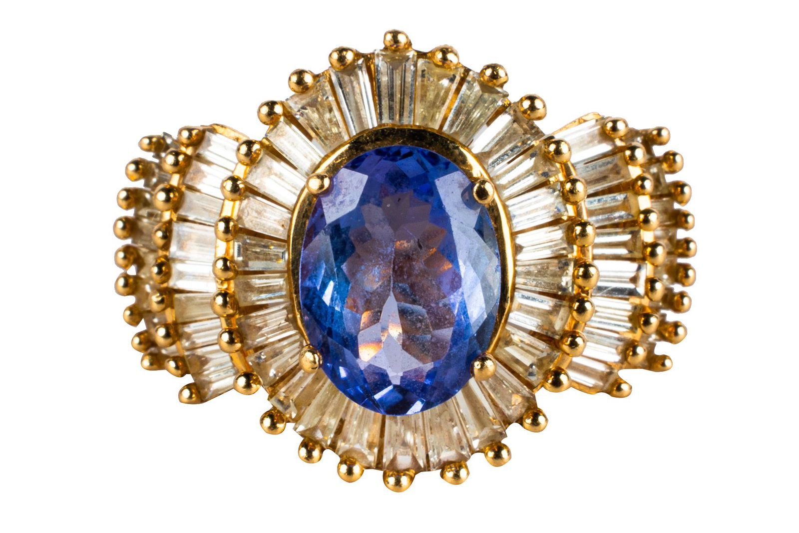 14 KARAT YELLOW GOLD, DIAMOND, & TANZANITE RING: centering one oval natural tanzanite weighing approximately 1.94 carats; and 60 tapered baguette diamonds H/VVS] weighing approximately 3.10 carats total 9.17 grams size: 6