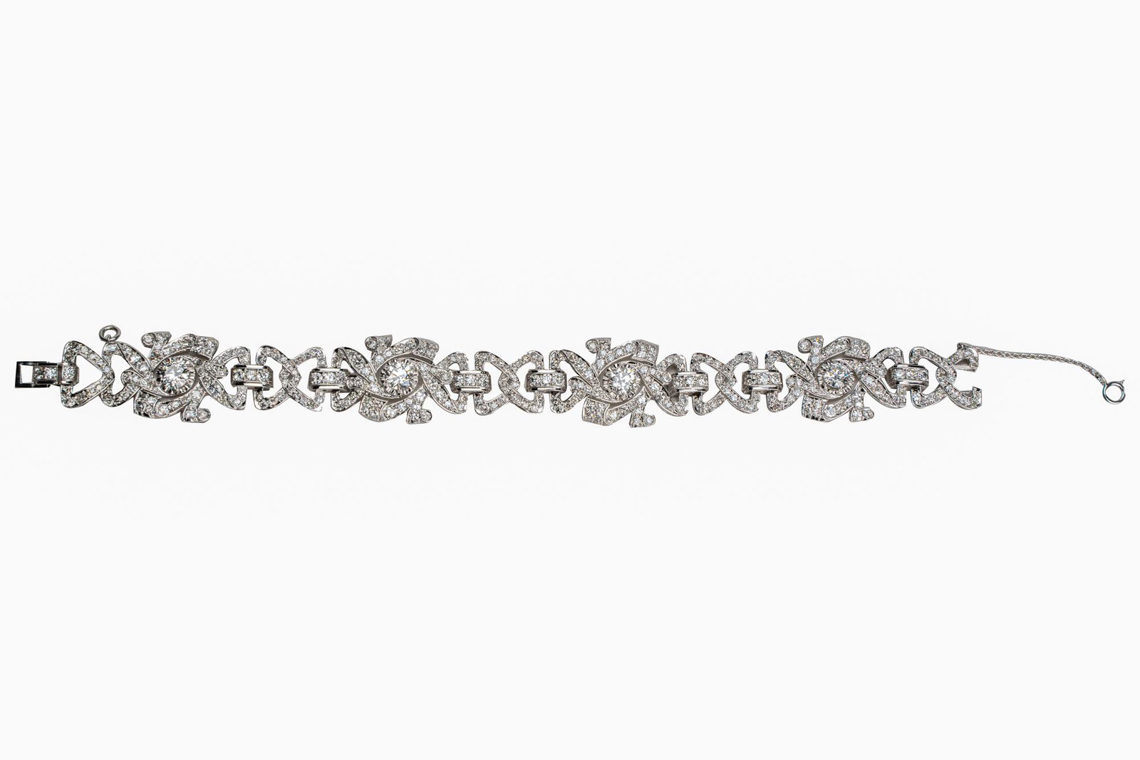 PLATINUM & DIAMOND BRACELET: containing four Old European cut diamonds [H-I/SI2-I1] weighing 2.60 carats total, surrounded by pave-set single cut diamonds [H-I/SI1-I1] weighing approximately 4.00 carats total 41.3 grams 7 1/4 inc