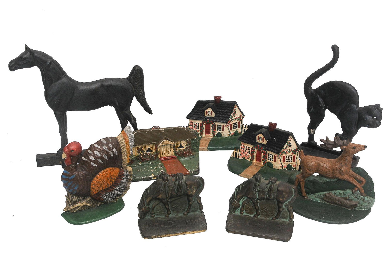 GROUP OF IRON DOOR STOPS & BOOKENDS: painted, patinated and enameled iron depicting animals and house facades Condition: with loss to paint and enamel throughout ranging from 4 to 11 1/2 inches high