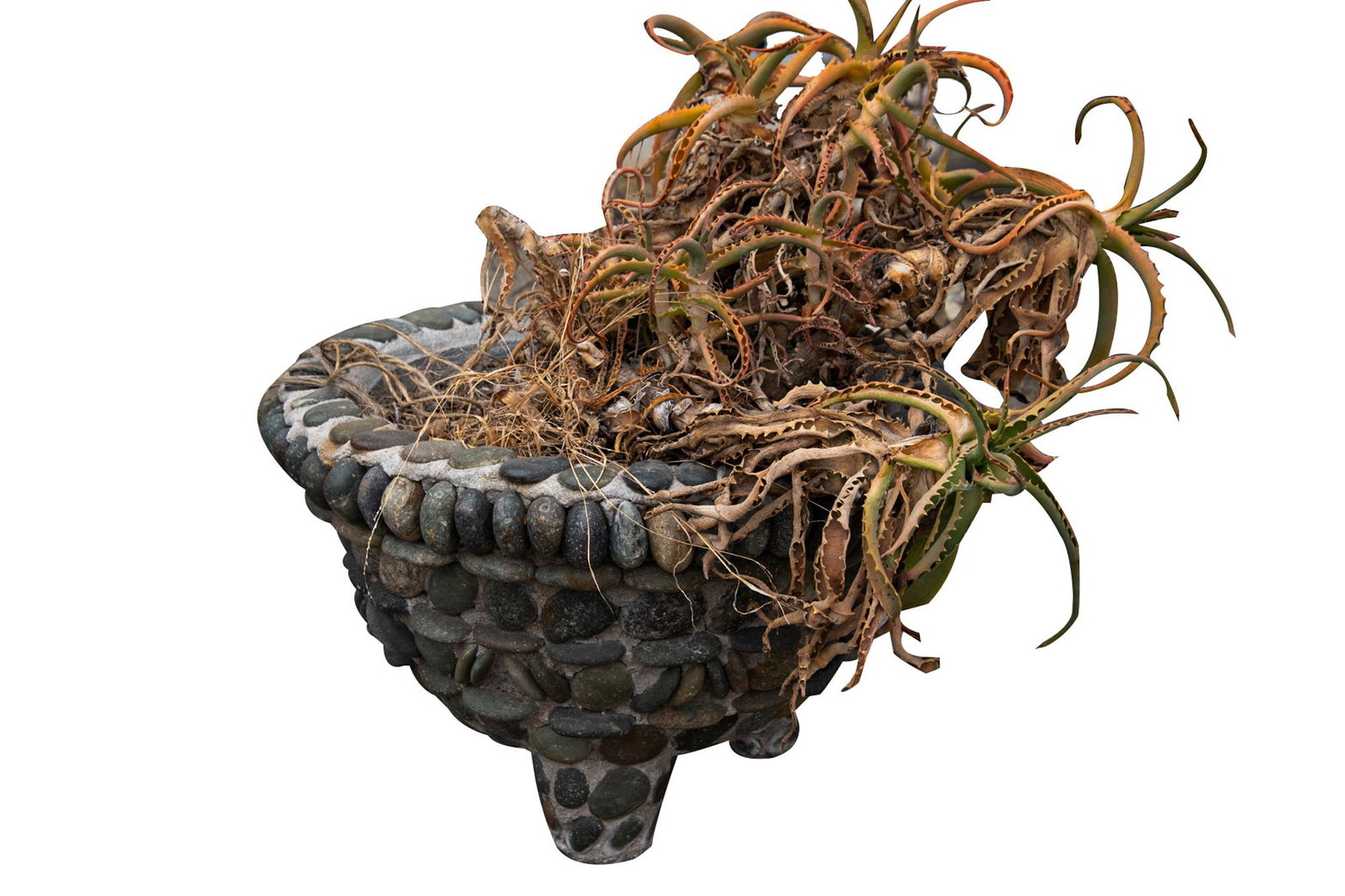 RIVER ROCK FOOTED PLANTER: earthenware coated in cement and river rocks Condition: weathered; with cracking and some rocks missing 23 inches diameter; 15 inches high