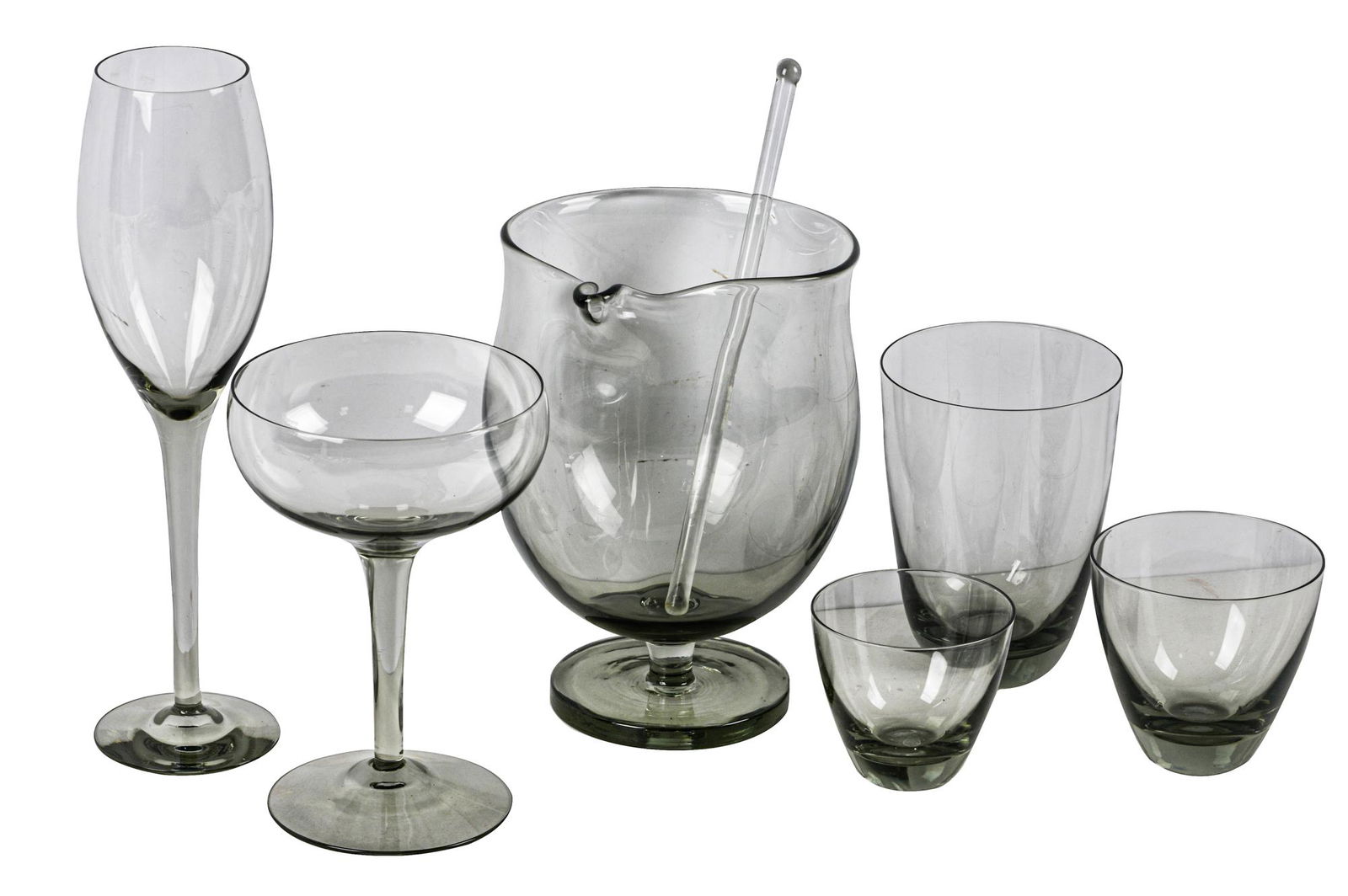 HOLMEGAARD DANISH SMOKED GLASS SERVICE: four retaining Holmegaard label, comprising: 1 footed pitcher with stirrer (7" high x 5 1/4" wide), 7 coupes (6" high), 6 flutes (9 3/4" high), 5 tumblers (4 3/4" high), 6 tumblers (3" high), 11 tumbl