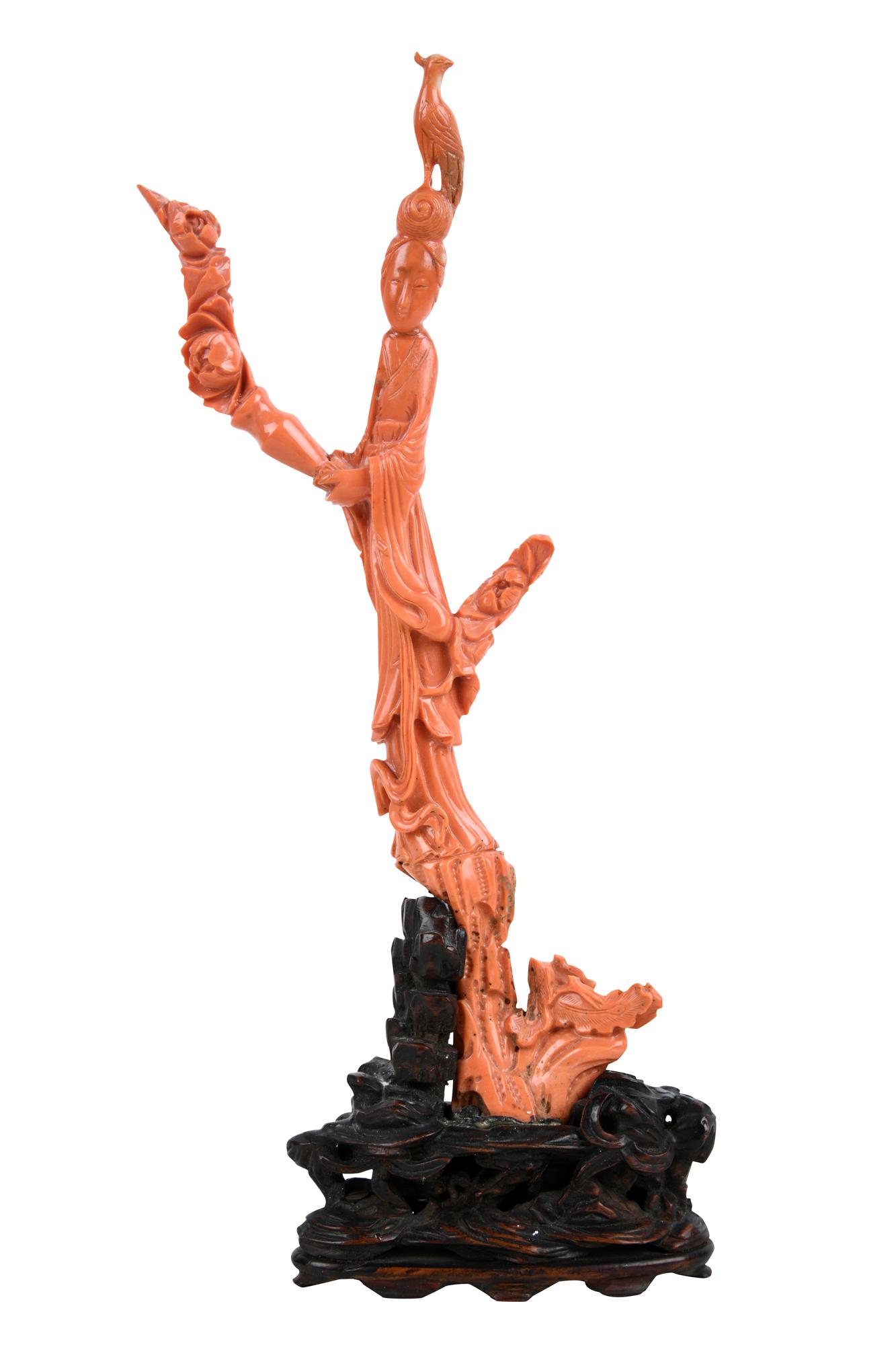 CHINESE CARVED CORAL FIGURE: mounted to a carved wood base Condition: with a few breaks and multiple restorations 13 1/4 inches high (including base: the coral alone: 11 1/4 inches high)