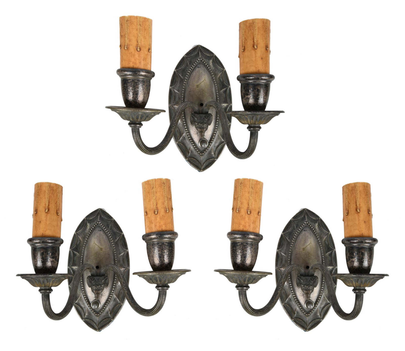 THREE SILVERED METAL RAMS HEAD SCONCES: Condition: with wear and discoloration throughout commensurate with age and use 9 inches wide; 5 1/2 inches deep; 8 inches high
