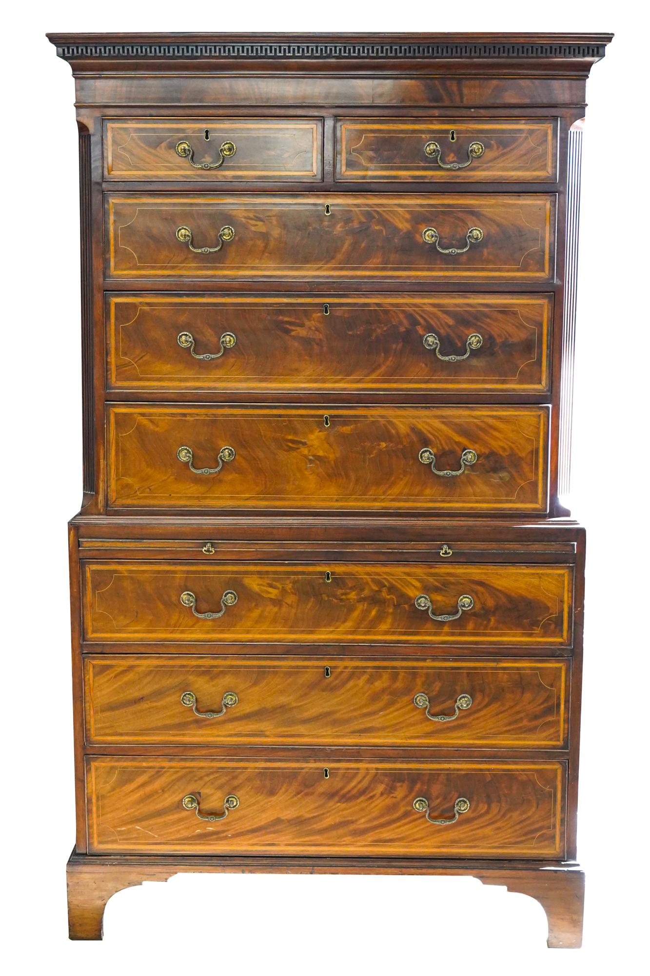 SCOTTISH INLAID MAHOGANY CHEST-ON-CHEST: second half 19th century, in two sections, the top section with Greek key-carved cornice and fluted, angled corners flanking two short drawers over three lonng drawers; the lower section with a slidin