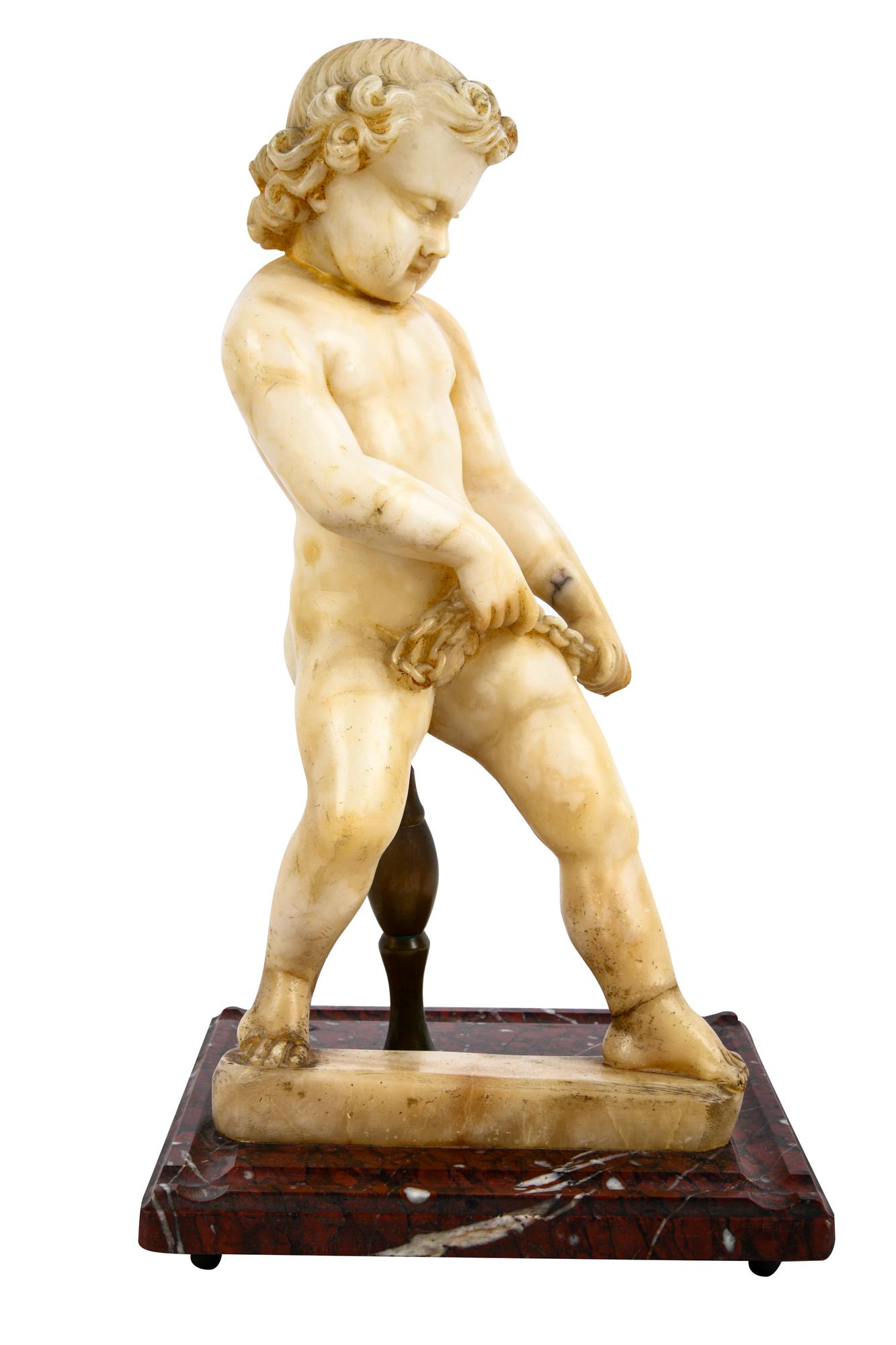 CARVED RUSSIAN ALABASTER CHERUB: on a rouge marble plinth 13 inches high