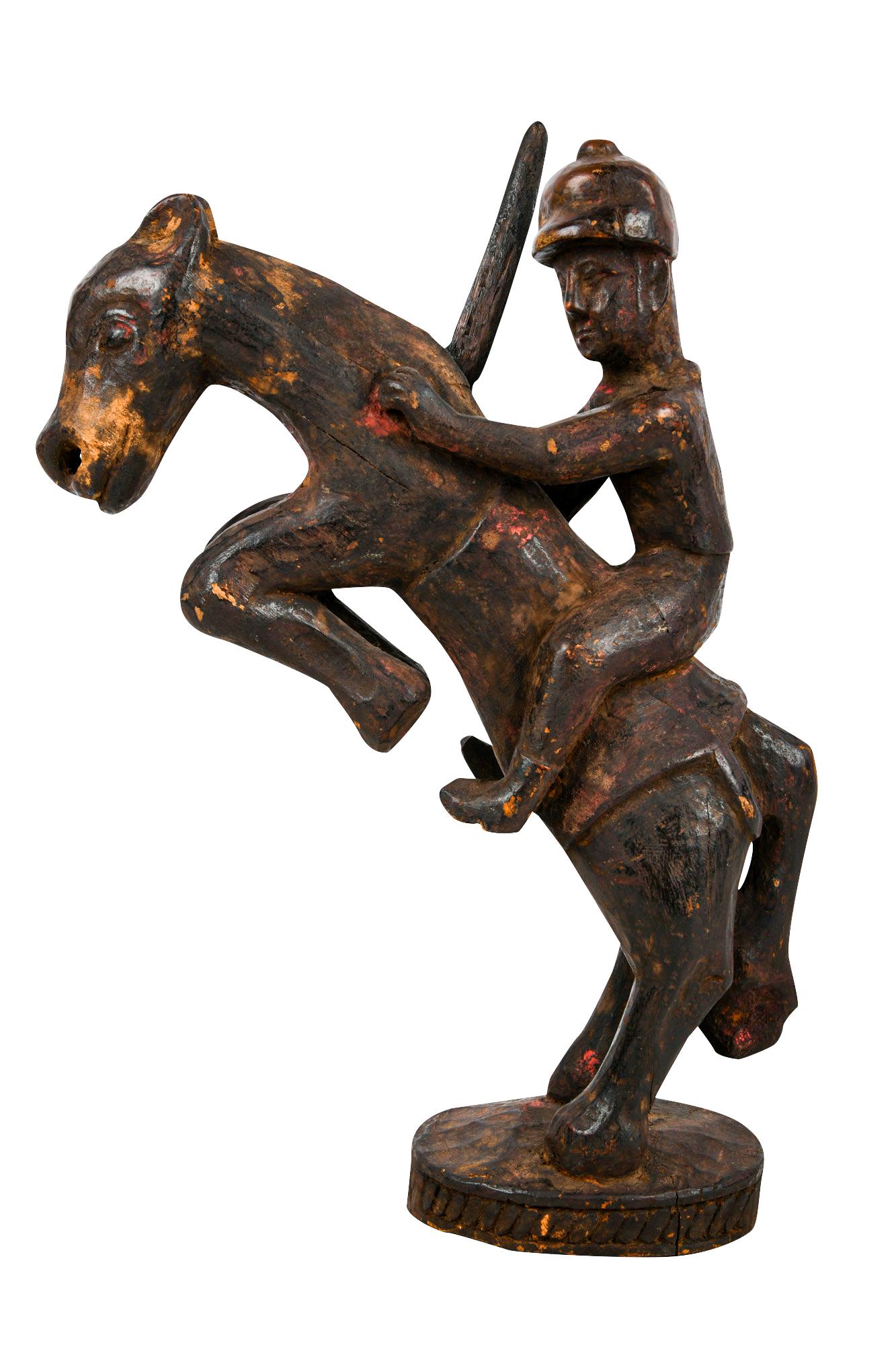 NEPALESE CARVED WOOD FIGURE ON HORSE BACK: with detachable sword Condition: some areas of rubbing and loss to horse's mouth and base 16 1/2 inches high