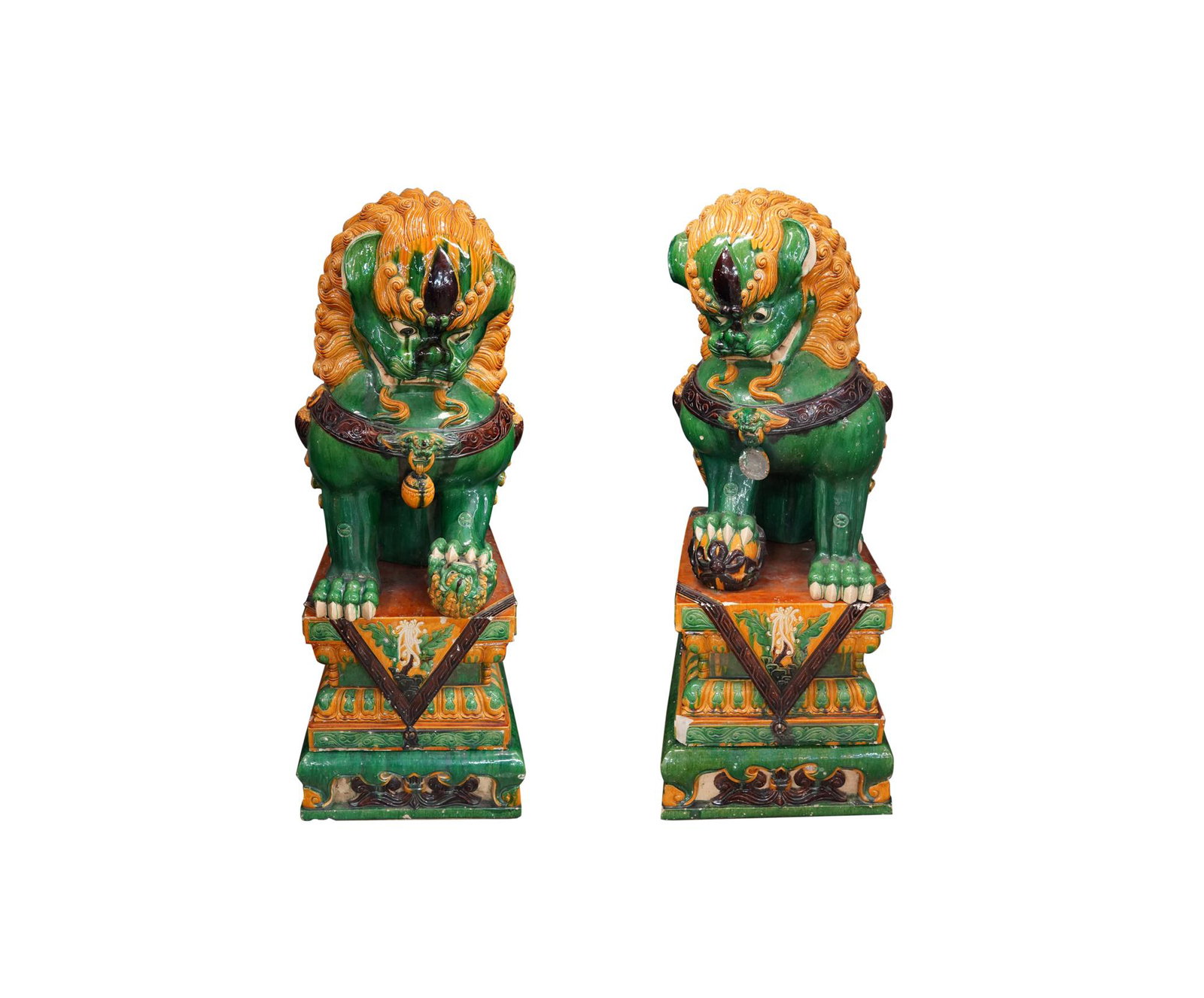 PAIR OF MONUMENTAL FOO DOGS: majolica; pair of foo dogs resting on terracotta pedestals; in three parts Condition: with loss throughout, foo dog with broken right foot and chips throughout foo dogs: 31 inches wide; 40 inches high