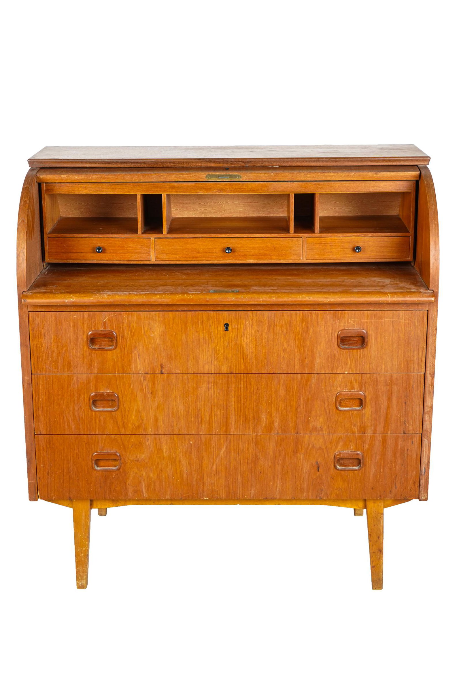 DANISH TEAK CYLINDER DESK: the cylinder opening to reveal three drawers and five cubbyholes Condition: with some surface scratches to roll top 35 inches wide; 18 inches deep; 39 inches high