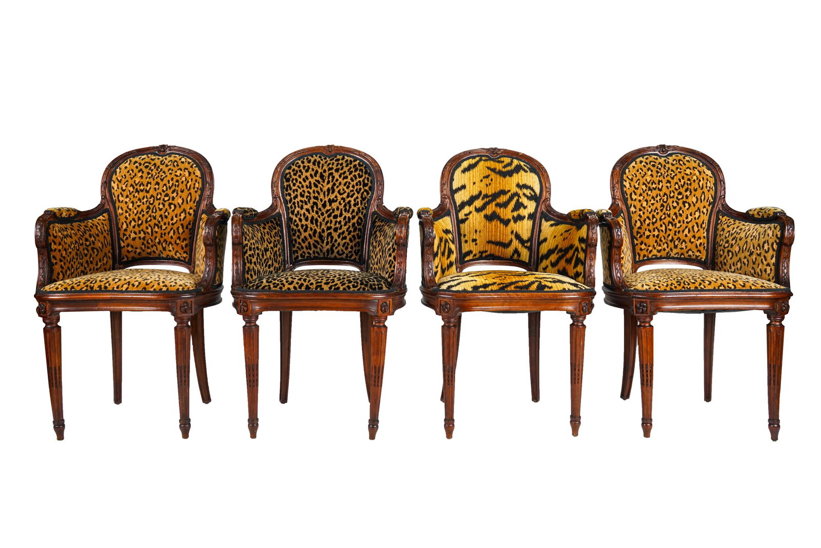 FOUR LOUIS XVI STYLE BERGERES: with mismatched animal-print upholstery Condition: slight separation at joints. Scattered minor nicks to frames. One with a repair to arm; arm moves slightly; chairs are otherwise structurally sound. 