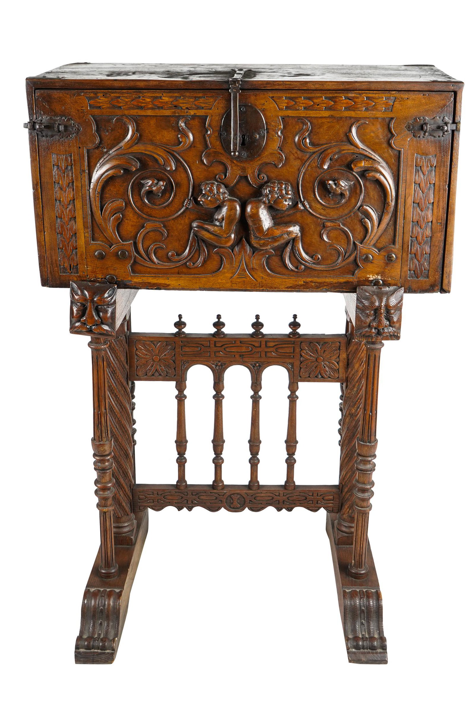 BAROQUE STYLE VARGUENO: with hinged drop-front opening to an arrangement of drawers, resting on a carved base Condition: with one pull missing to interior drawer 34 inches wide; 14 1/2 inches deep; 49 total inches high