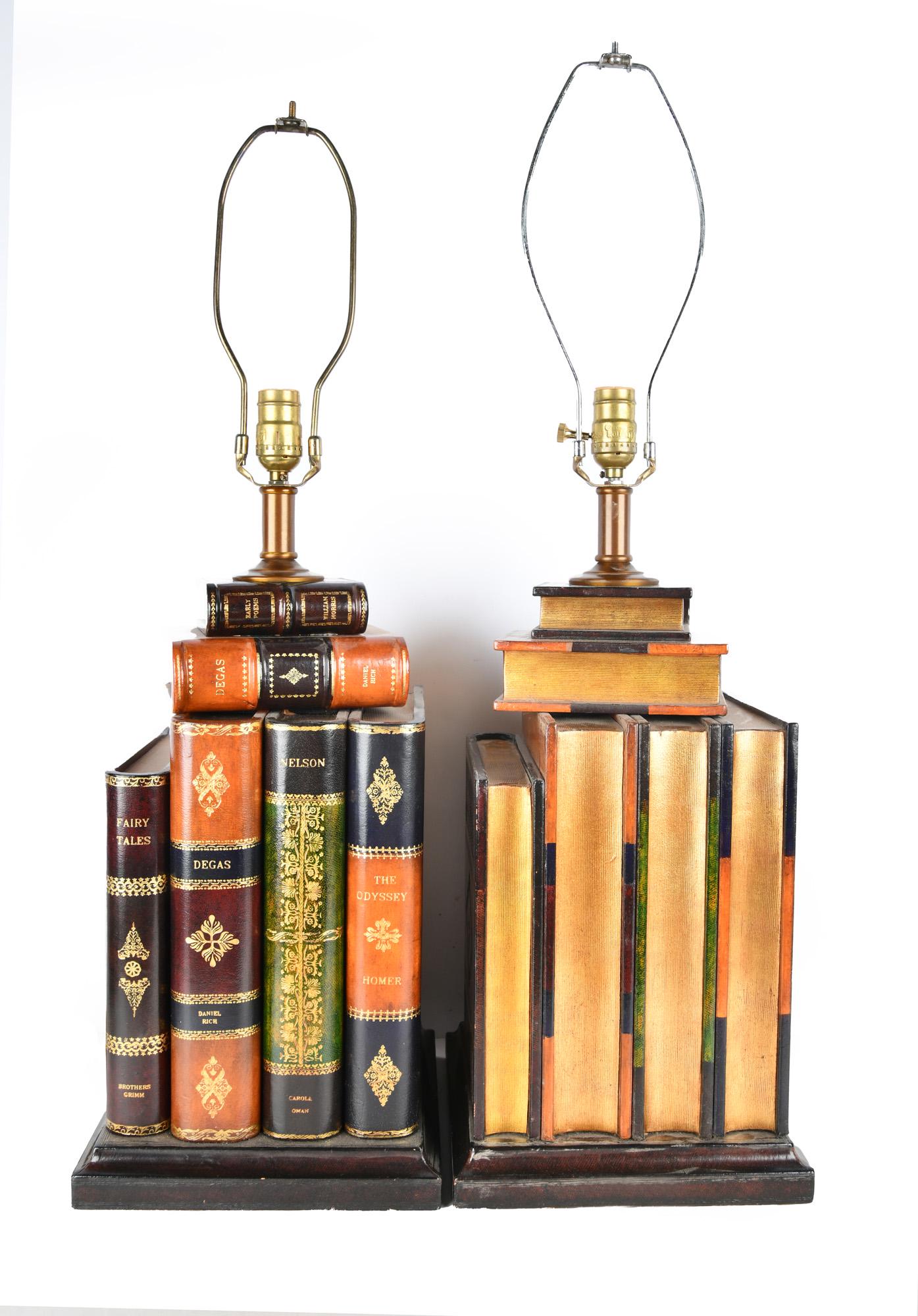 PAIR OF MAITLAND-SMITH BOOK FORM LAMPS: Condition: with mismatched harps and no finials; with light scuffs and scratches lower on bases of each lamp to top of socket: 22 inches high