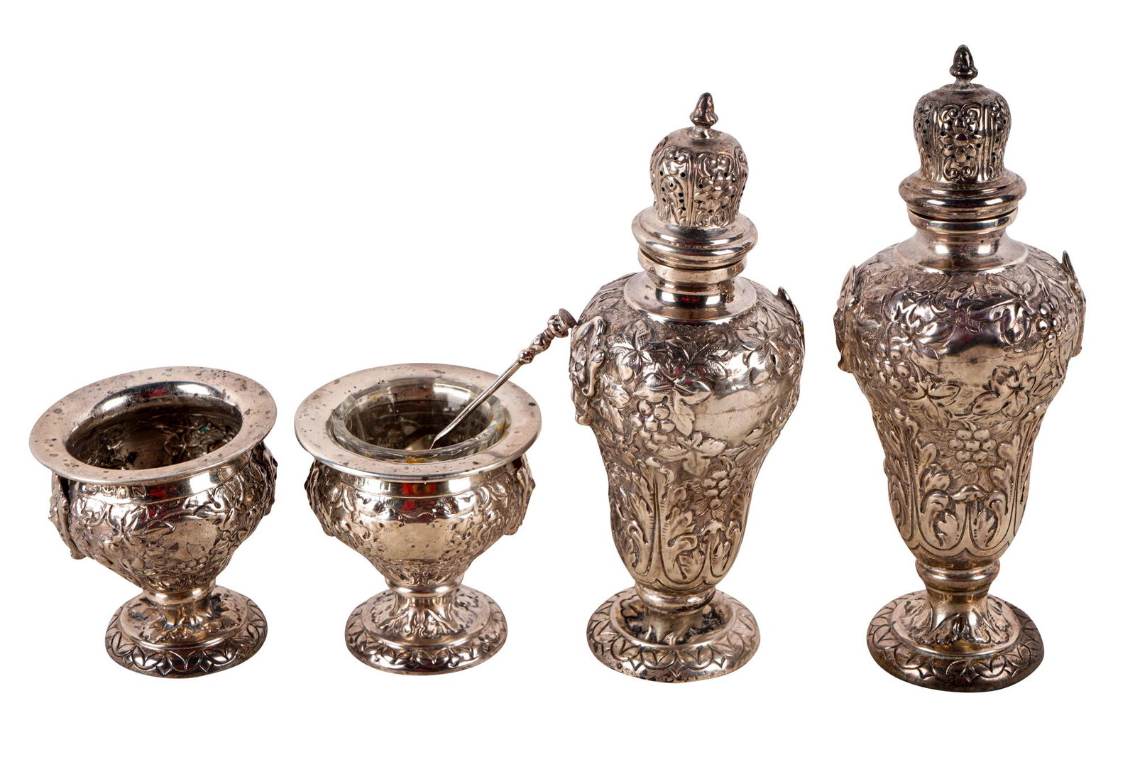 GROUP OF SILVER CASTERS & SALT CELLARS: comprising a pair of casters and a matching pair of salts, no apparent maker's marks or hallmarks, one salt marked "Made in England", each repousse-decorated with grapevines and masks, the salts each 