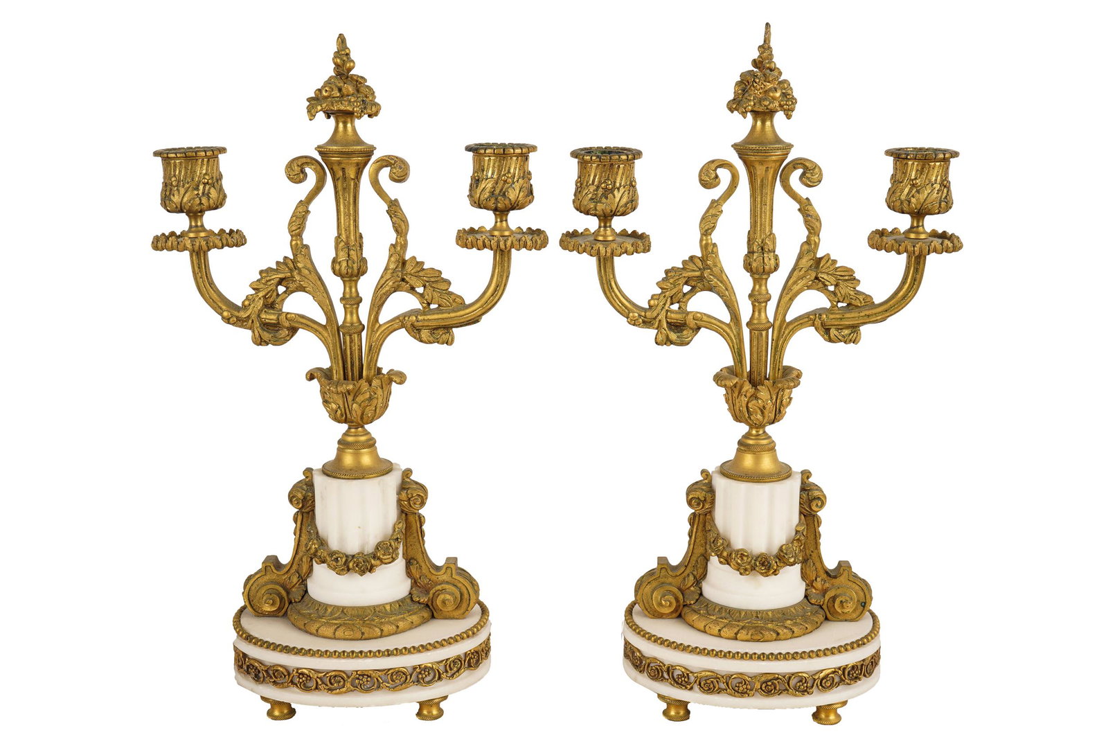 PAIR OF FRENCH TWO-LIGHT CANDELABRA: gilt metal and white marble each resting on four feet Condition: slight oxidation to feet 8 1/4 inches wide; 14 inches high