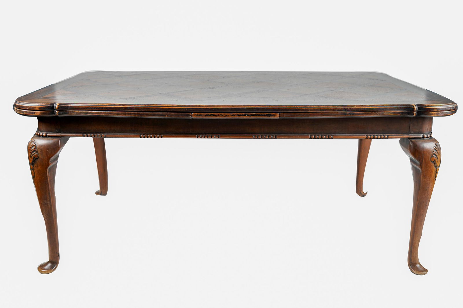 FRENCH PROVINCIAL STYLE CARVED WALNUT DINING TABLE: with parquetry top Condition: scratches to top commensurate with use 70 inches wide; 44 inches deep; 30 1/2 inches high