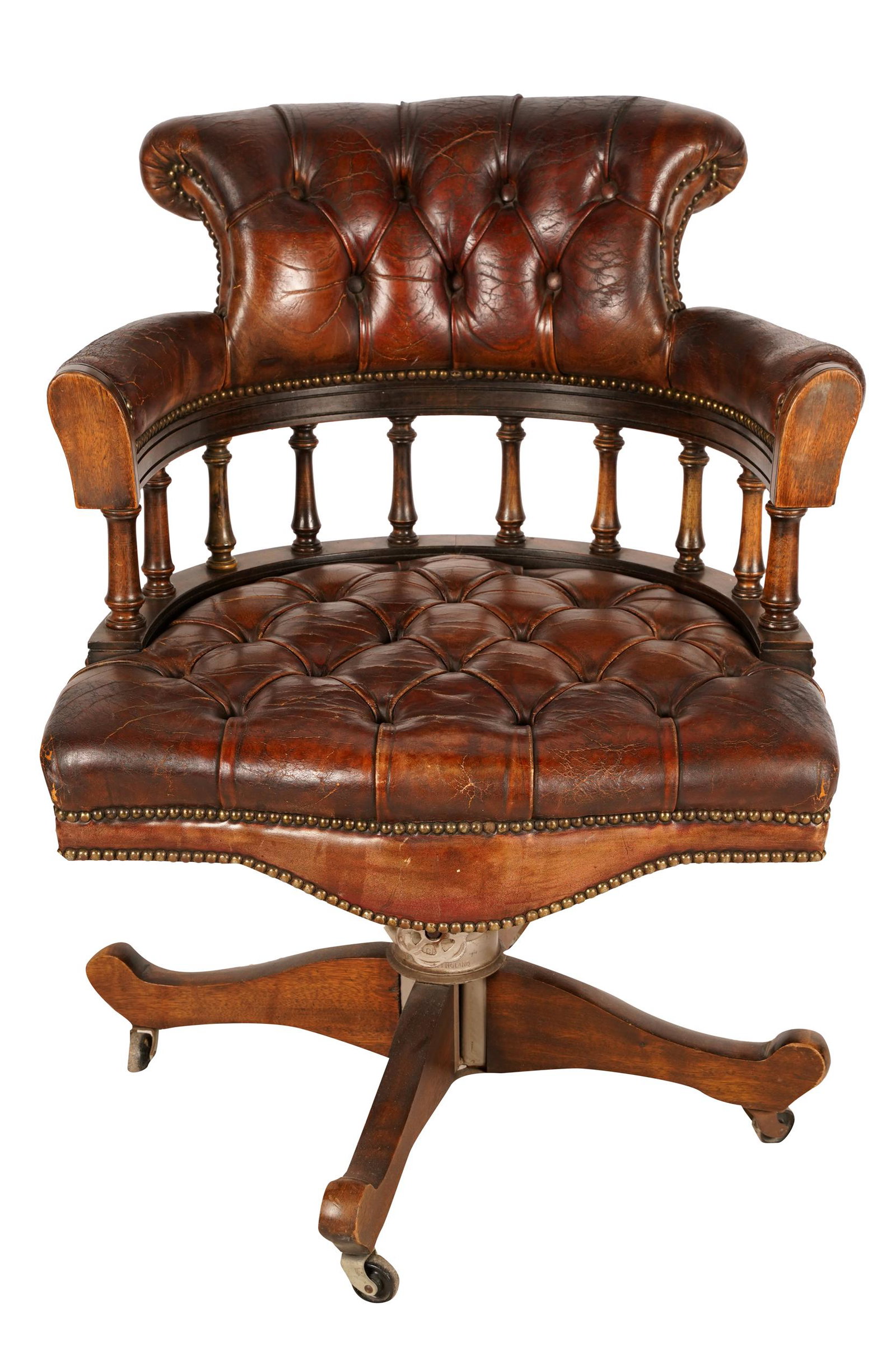 LEATHER & WOOD SWIVEL CHAIR: with label "Reg'd Trade MarkHillcrest Chair Actions", covered with brown leather with nail head trim and raised on metal casters 25 1/2 inches wide; 22 1/2 inches deep; 34 inches high; seat height: 19