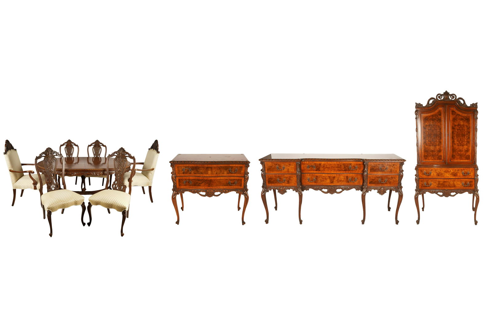 CARVED MAHOGANY DINING SET: circa 1920s, comprising an oval table (69 inches wide closed; 46 inches deep; 30 inches high), four leaves (each 11 inches wide), a buffet (74 inches wide; 21 inches deep; 36 1/2 inches high), a serve