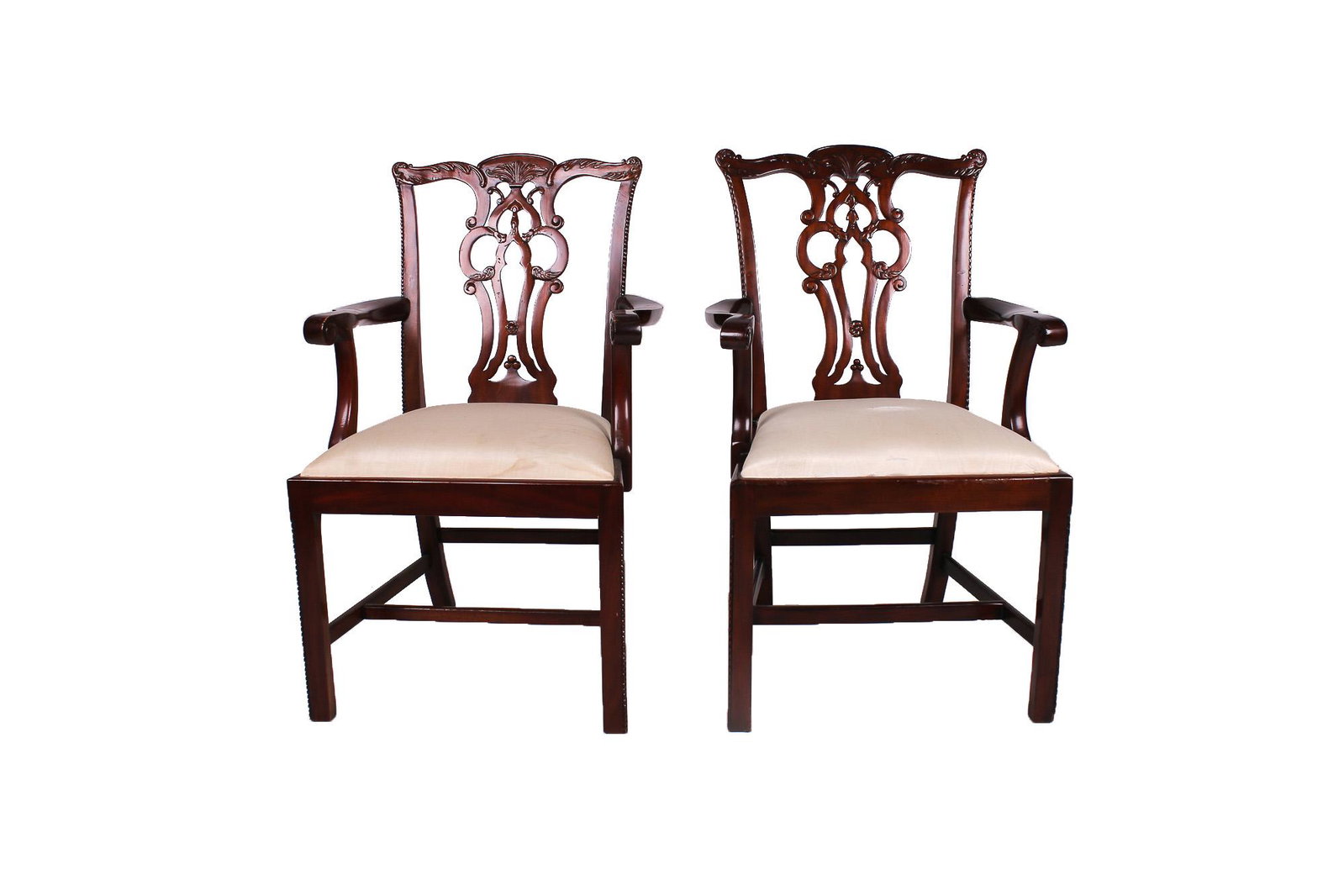 EIGHTEEN CHIPPENDALE STYLE MAHOGANY DINING CHAIRS: covered off-white watered silk Condition: with wear to arms commensurate with use. 24 1/2 inches wide; 20 inches deep; 38 inches high; seat height: 19 inches
