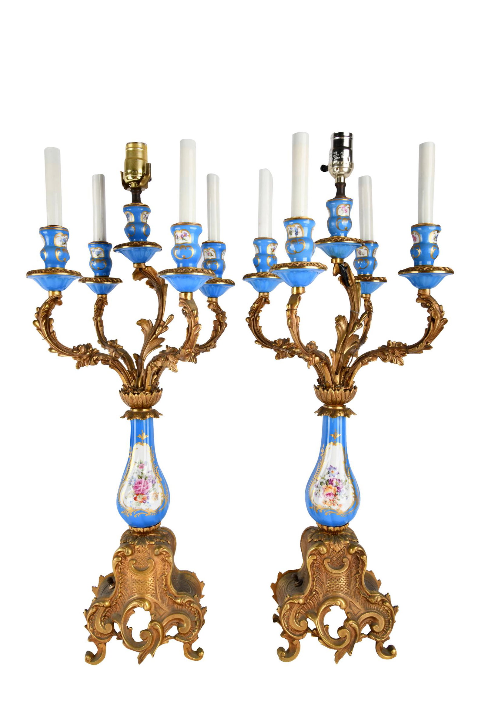 PAIR OF PORCELAIN & GILT METAL CANDELABRA: each with five lights Condition: electrified. Working condition untested and unknown. Heavy rubbed wear and discoloration to gilding. 12 inches diameter; 28 1/4 inches to top of cup
