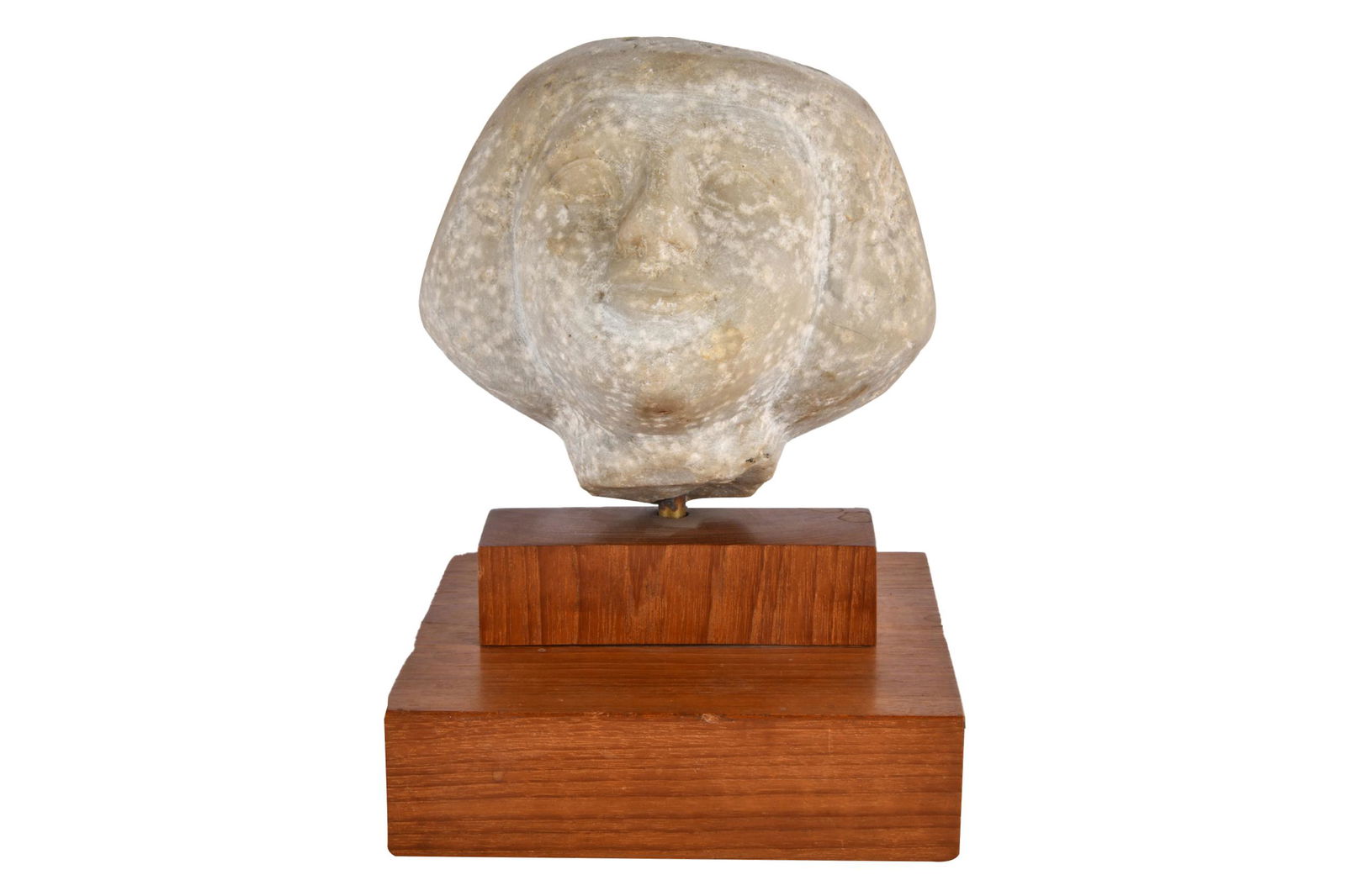 CARVED STONE HEAD: on a stepped wooden base Condition: bust drilled for stand; the base: 6 1/2 inches wide; 6 1/4 inches deep; 8 3/4 total inches high the bust: 6 1/2 inches wide; 6 inches deep; 6 inches high