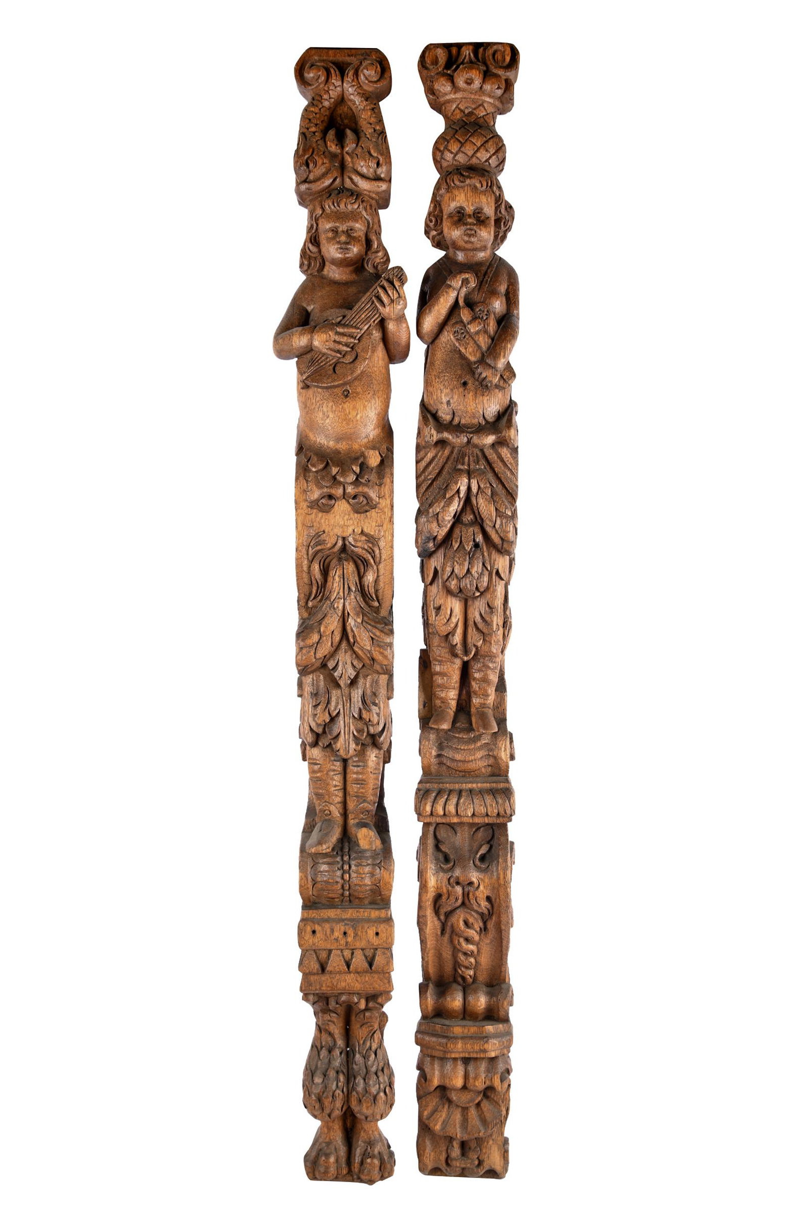 PAIR OF SPANISH CARVED WOOD PILLARS: figural design Condition: with hanging eye hooks 45 inches high; 3 3/4 inches wide