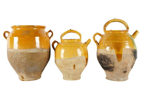 THREE GLAZED EARTHENWARE JARS: unsigned, of various sizes Provenance: The Estate of Judith Krantz, Bel Air Condition: the largest with chips to rim. the largest: 16 inches high; the smallest: 13 1/2 inches high