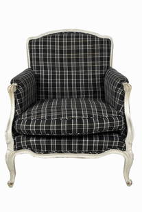 WHITE-PAINTED LOUIS XV STYLE BERGERE: covered in black and white checked linen / cotton fabric, with loose seat cushion Provenance: The Estate of Judith Krantz, Bel Air Condition: wear to paint throughout. 29 1/2 inches wide; 28 inches