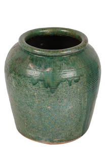 GREEN-GLAZED CERAMIC GARDEN URN: unmarked Provenance: The Estate of Judith Krantz, Bel Air Condition: with wear and losses to glaze. Firing imperfections. 18 inches diameter; 20 inches high