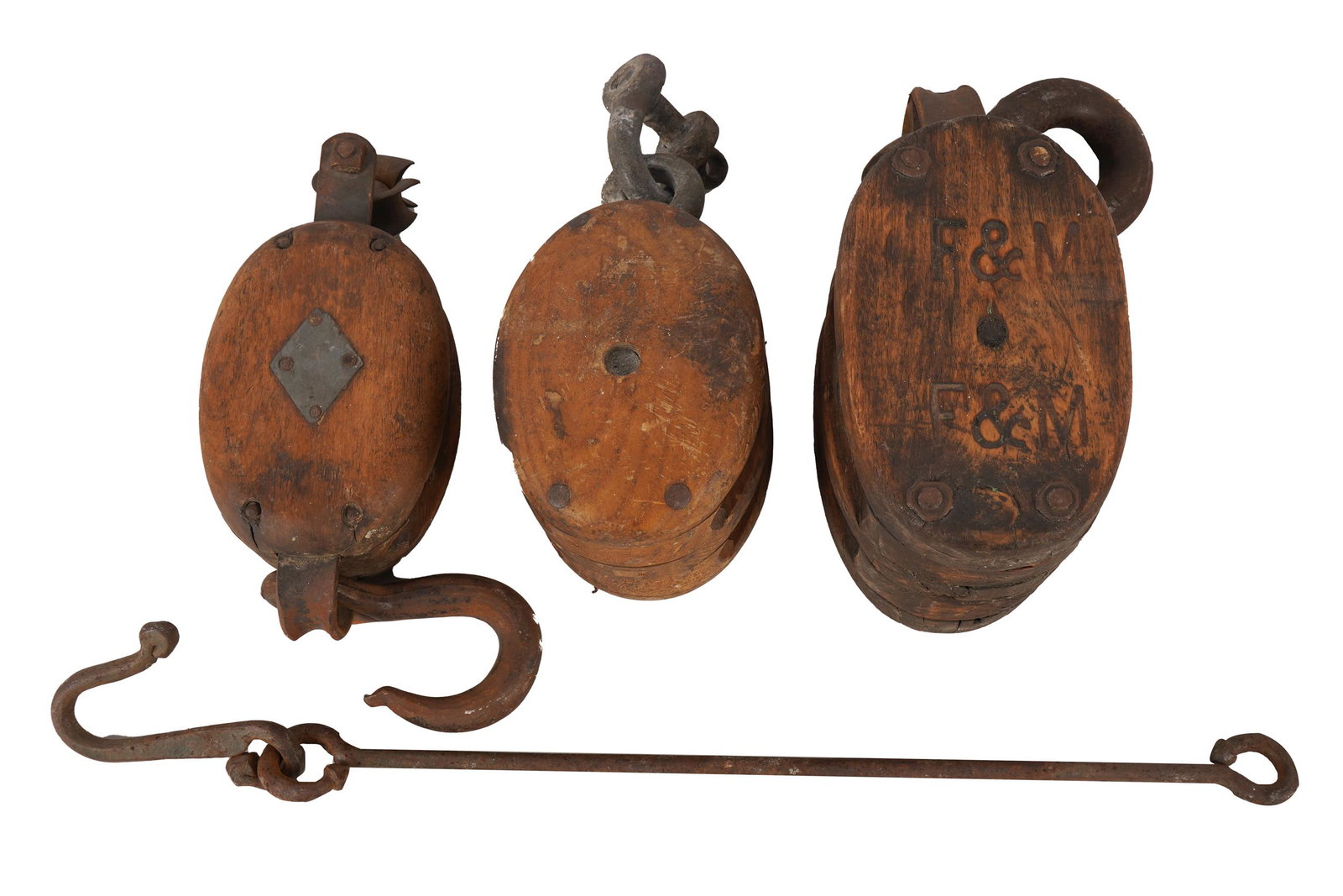 THREE ANTIQUE SHIP PULLEYS: wood and metal Condition: heavy wear commensurate with age and use the largest: 14 inches wide
