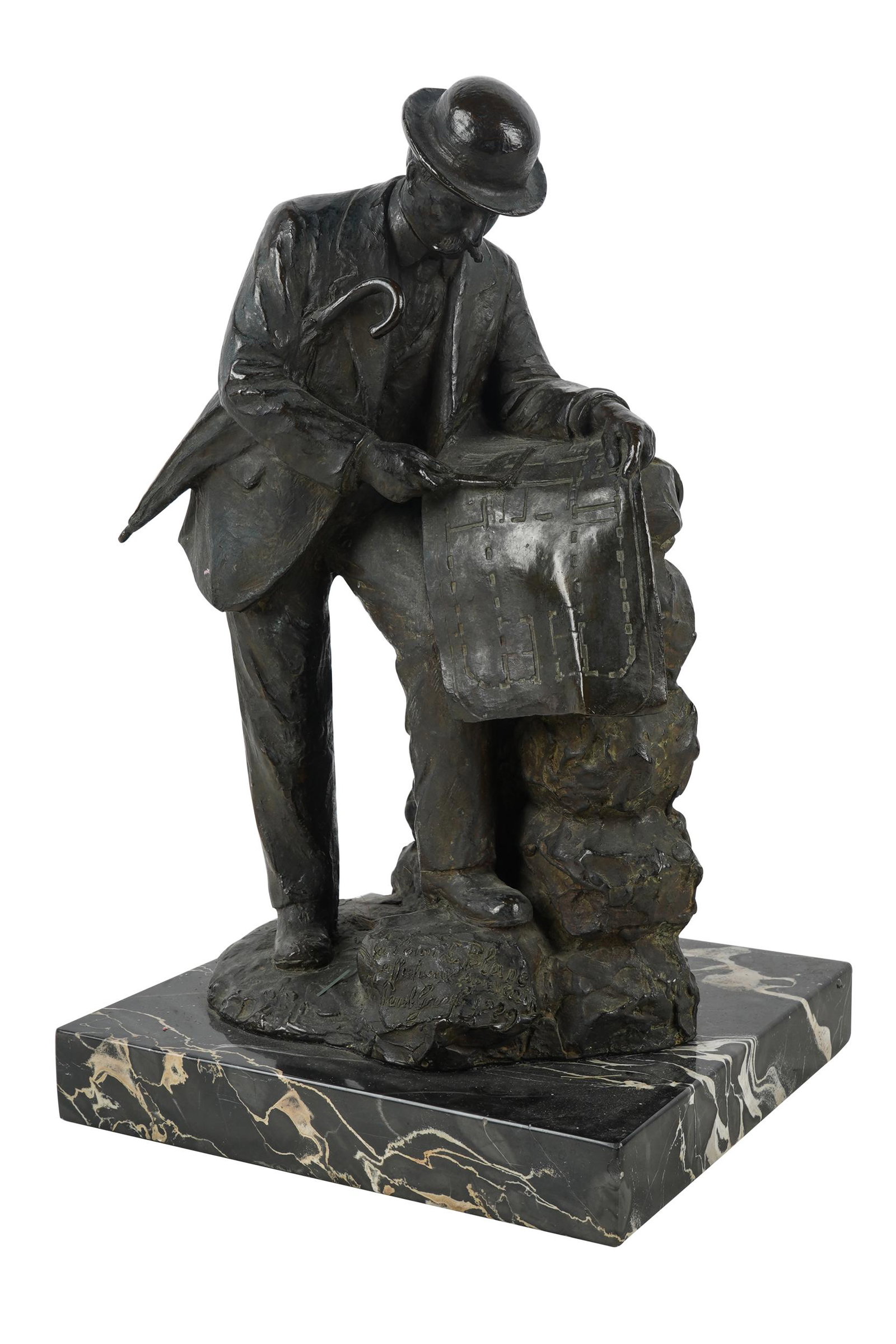 PATINATED BRONZE FIGURE: signed and dated "Paul Graf 1929" and with inscription, depicting a man reading a blueprint; mounted to a marble plinth the bronze 13 inches high; the base 9 inches wide; 8 1/2 inches deep; 1 1/2 inch