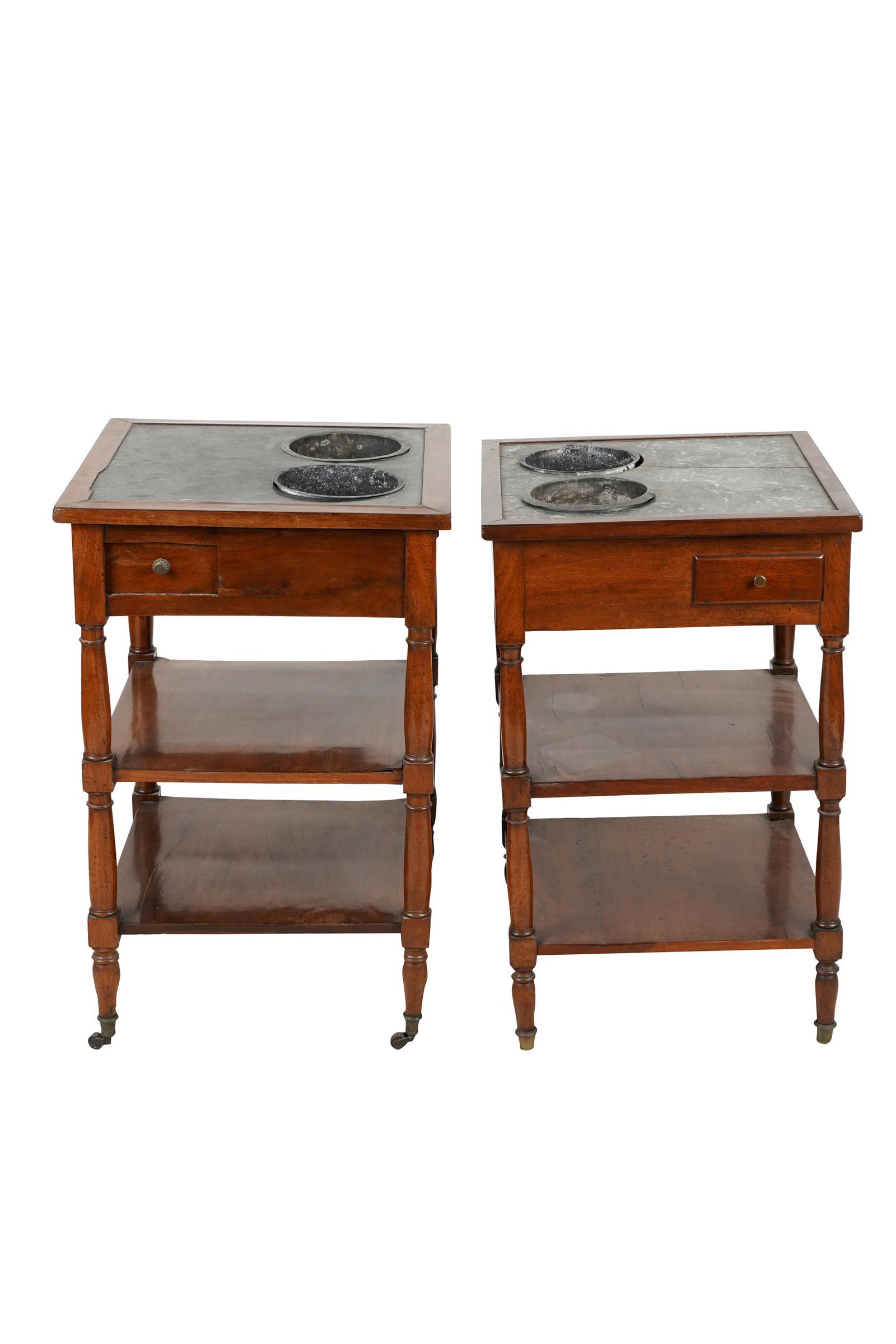 PAIR OF FRENCH CARVED MAHOGANY RAFRAICHISSOIRS: each with square inset stone top with two round wells, over a small drawer above two shelves Condition: the stone tops varying in color. Slight variations in size. Each with cracks throughout top. eac