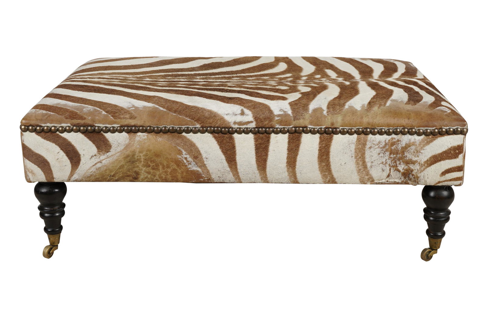 HIDE-UPHOLSTERED OTTOMAN: on casters 48 inches wide; 34 inches deep; 18 inches high