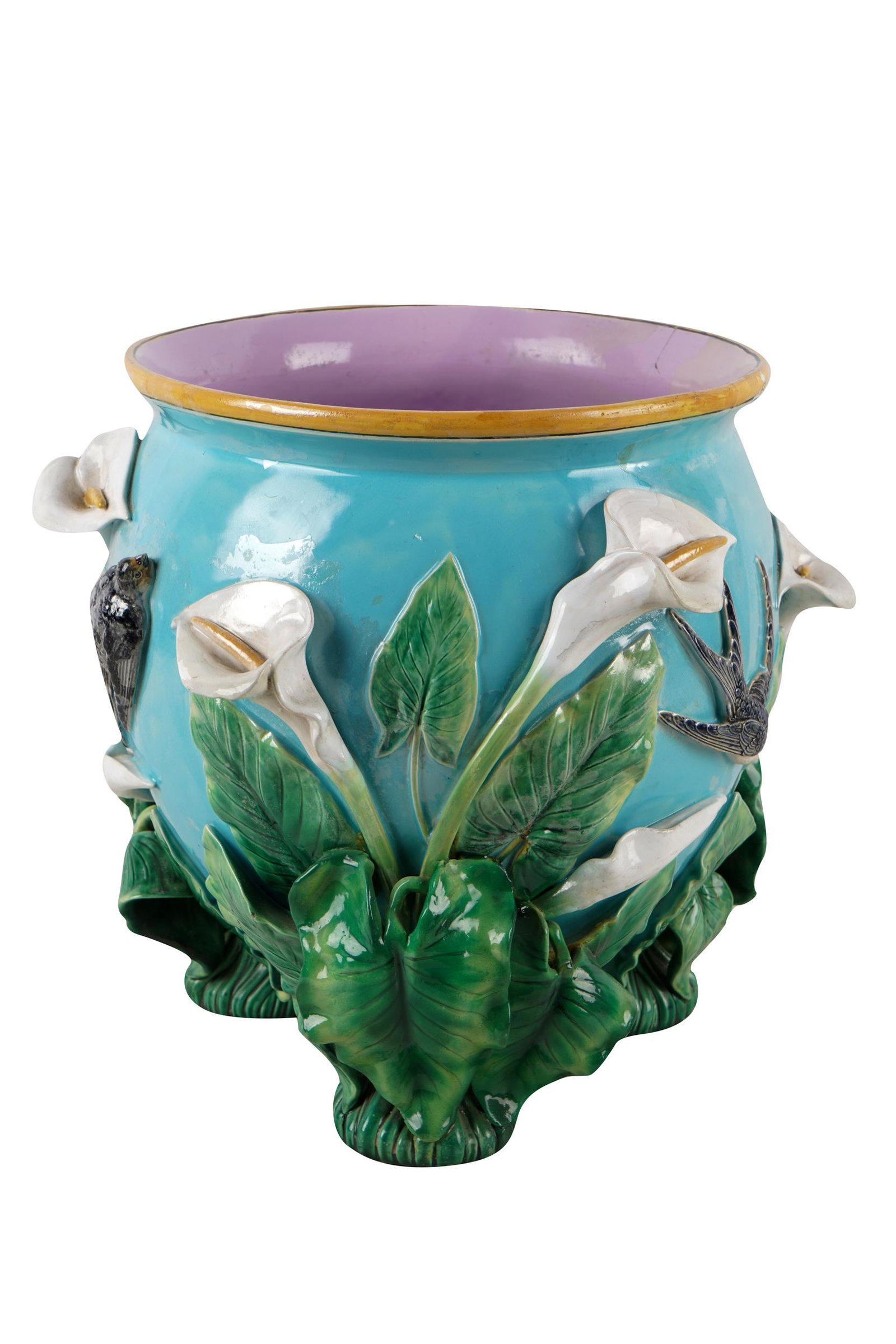GEORGE JONES: MAJOLICA JARDINIERE: Second half 19th century, with "GJ" cypher and diamond registration mark to underside of each foot; the body decorated with molded swallows and calla lilies rising from each of the three foliate feet 