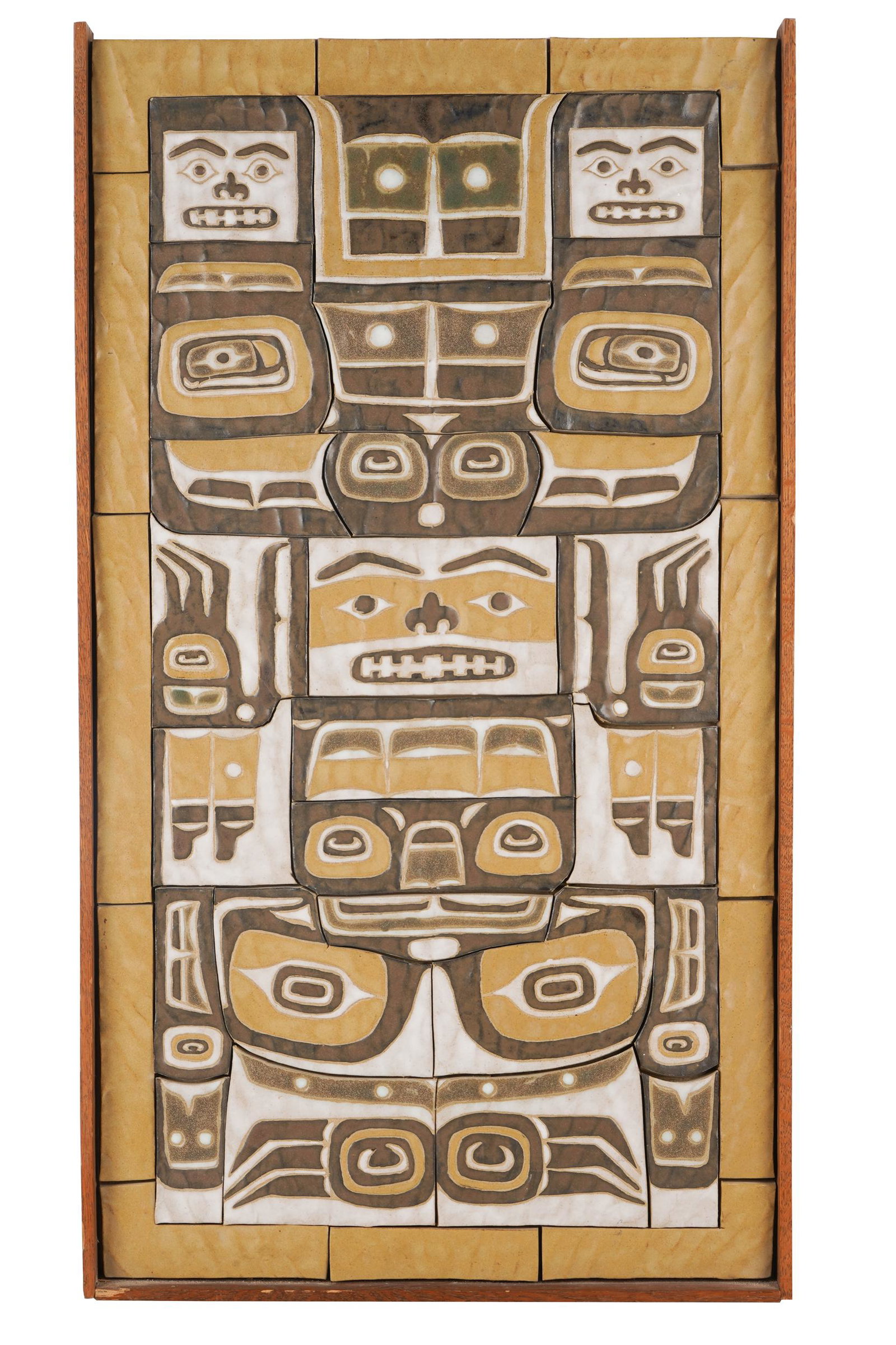 TILE PLAQUE OF FACES: set in wood frame Condition: top of wood frame missing 31 x 17 inches framed