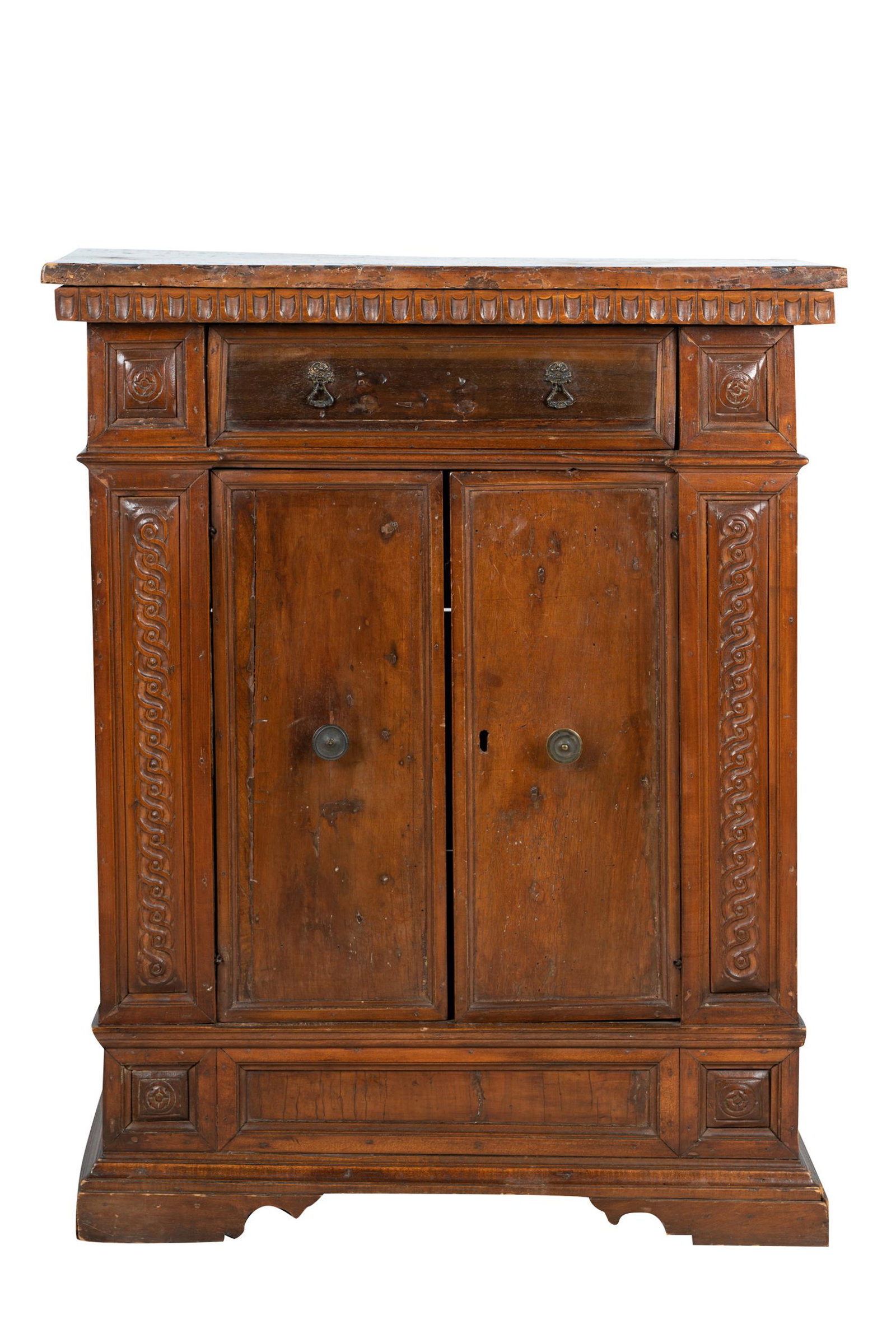 ITALIAN CARVED WALNUT CABINET: 18th/19th century, having a drawer over a pair of hinged doors concealing a shelf; Condition: a water mark and an 8 inch-long split to top. Age cracks throughout. No key; 29 1/2 inches wide; 12 1/2 in