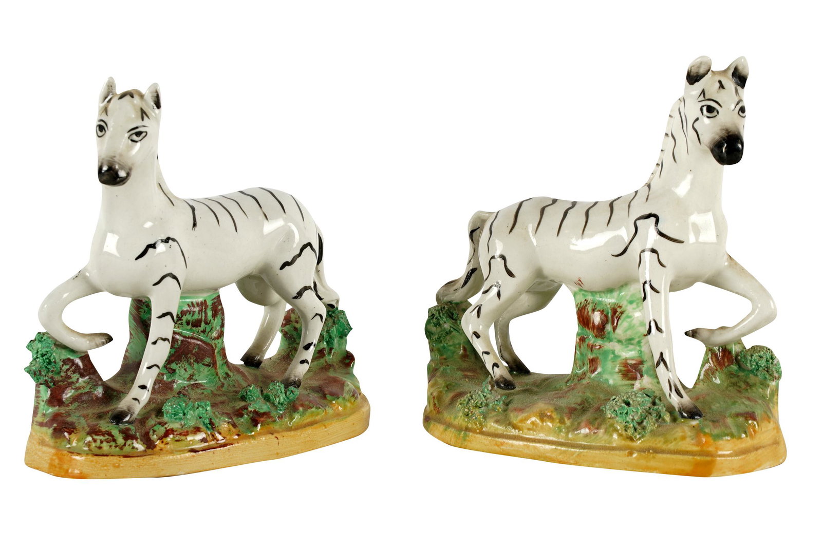 PAIR OF STAFFORDSHIRE ZEBRAS: each with printed "Staffordshire / England" and knot mark to underside Provenance: The Estate of Stephen W. Royce Sr. 4 1/4 inches wide; 2 1/4 inches deep; 4 3/4 inches high