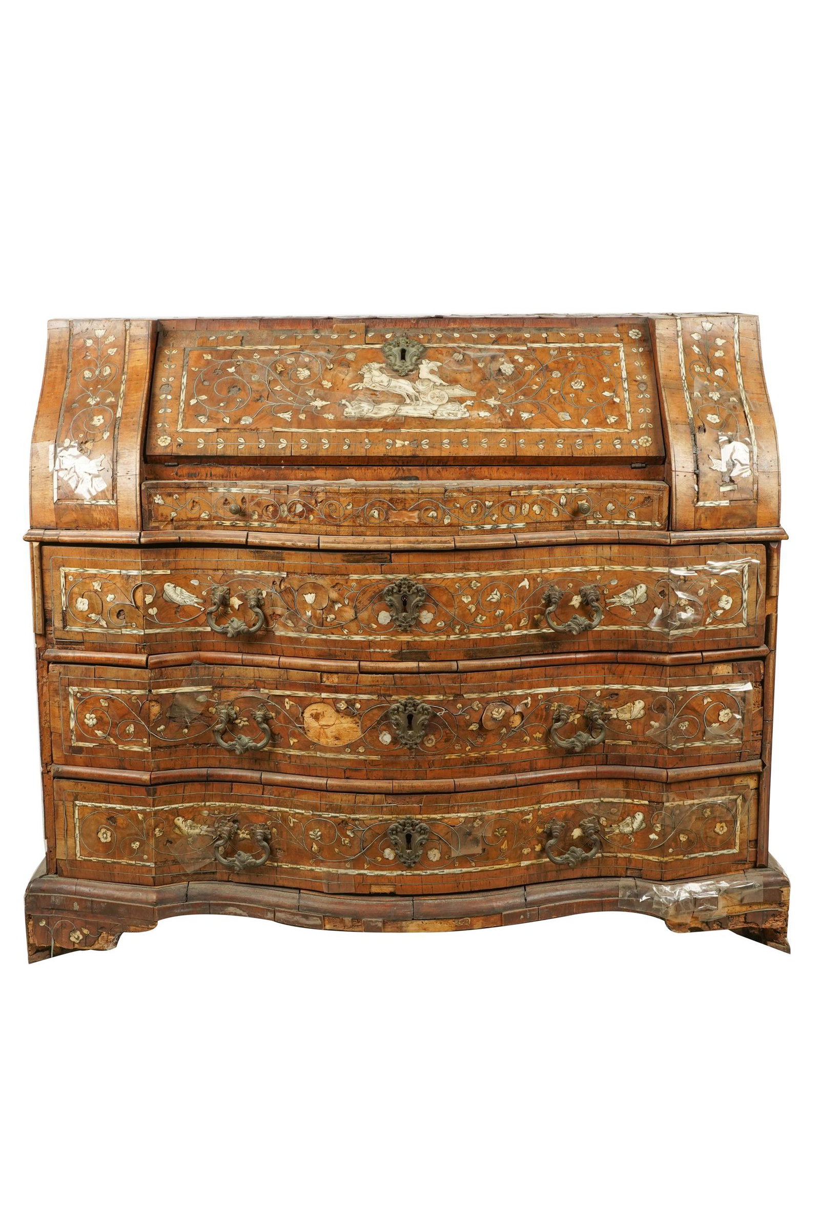 ITALIAN CARVED WALNUT & INLAID SECRETARY: the hinged slant front writing surface opens to reveal a fitted interior with four drawers and a single door; Condition: loss to veneer, inlay and warping throughout ; 47 inches wide; 22 inches deep; 