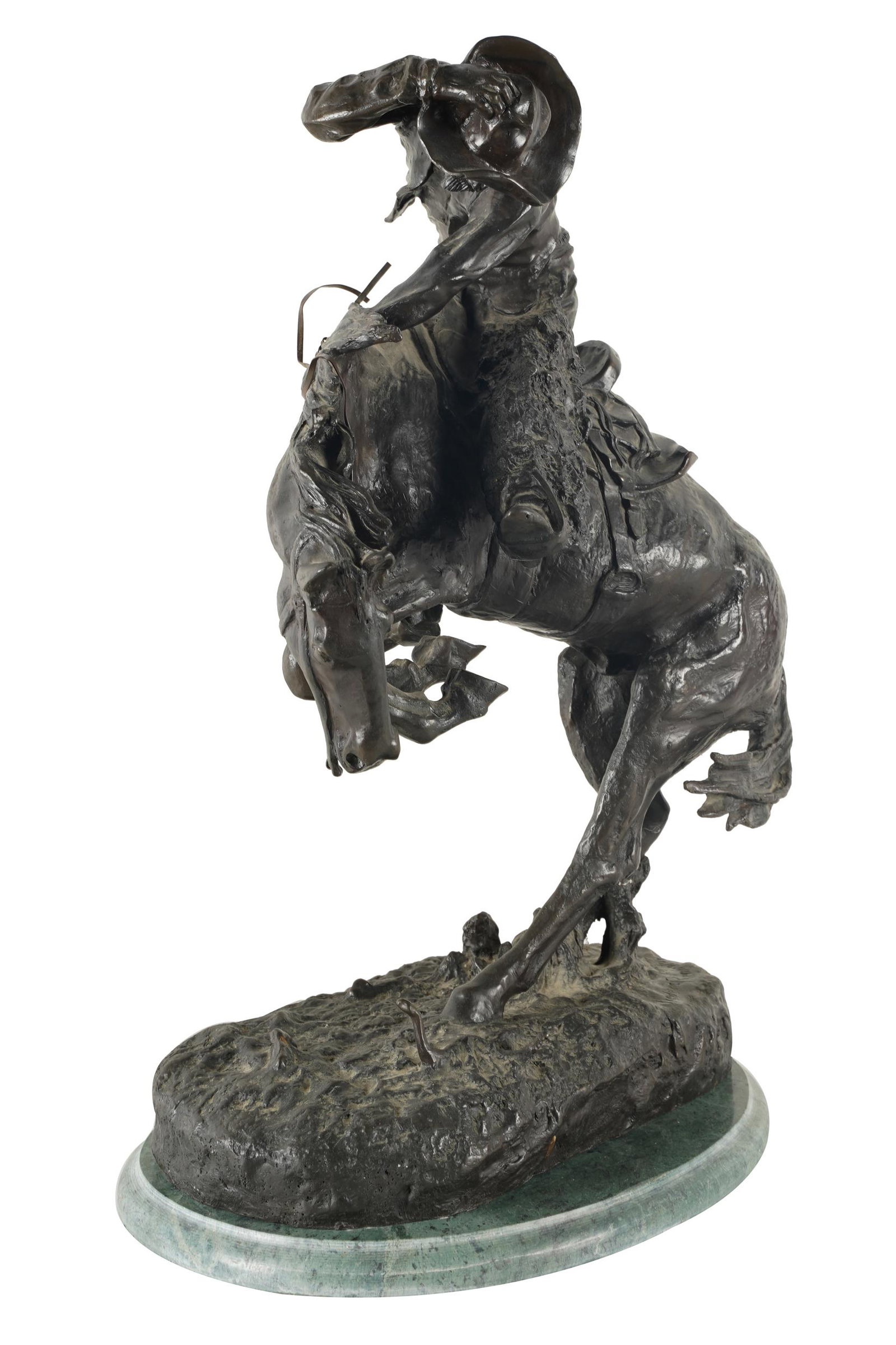 FREDERIC REMINGTON: BRONCO BUSTER: signed to base "copyright / Frederic Remington"; patinated bronze; mounted to a green marble plinth; Condition: no apparent foundry mark; overall dust accumulation; a few areas of small white marks to